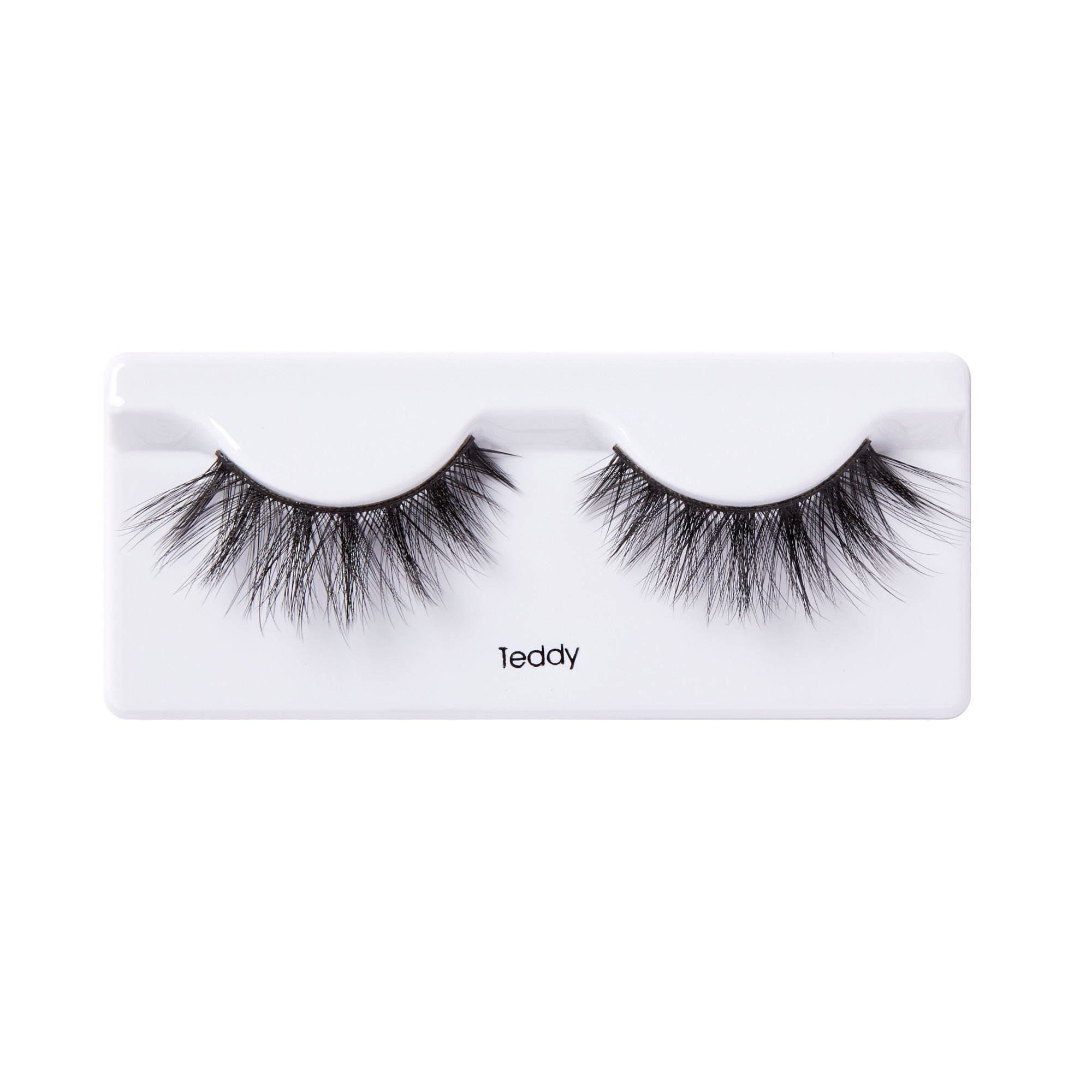 Pair of black, voluminous false eyelashes with a wispy, layered design, displayed on a white plastic tray labeled \