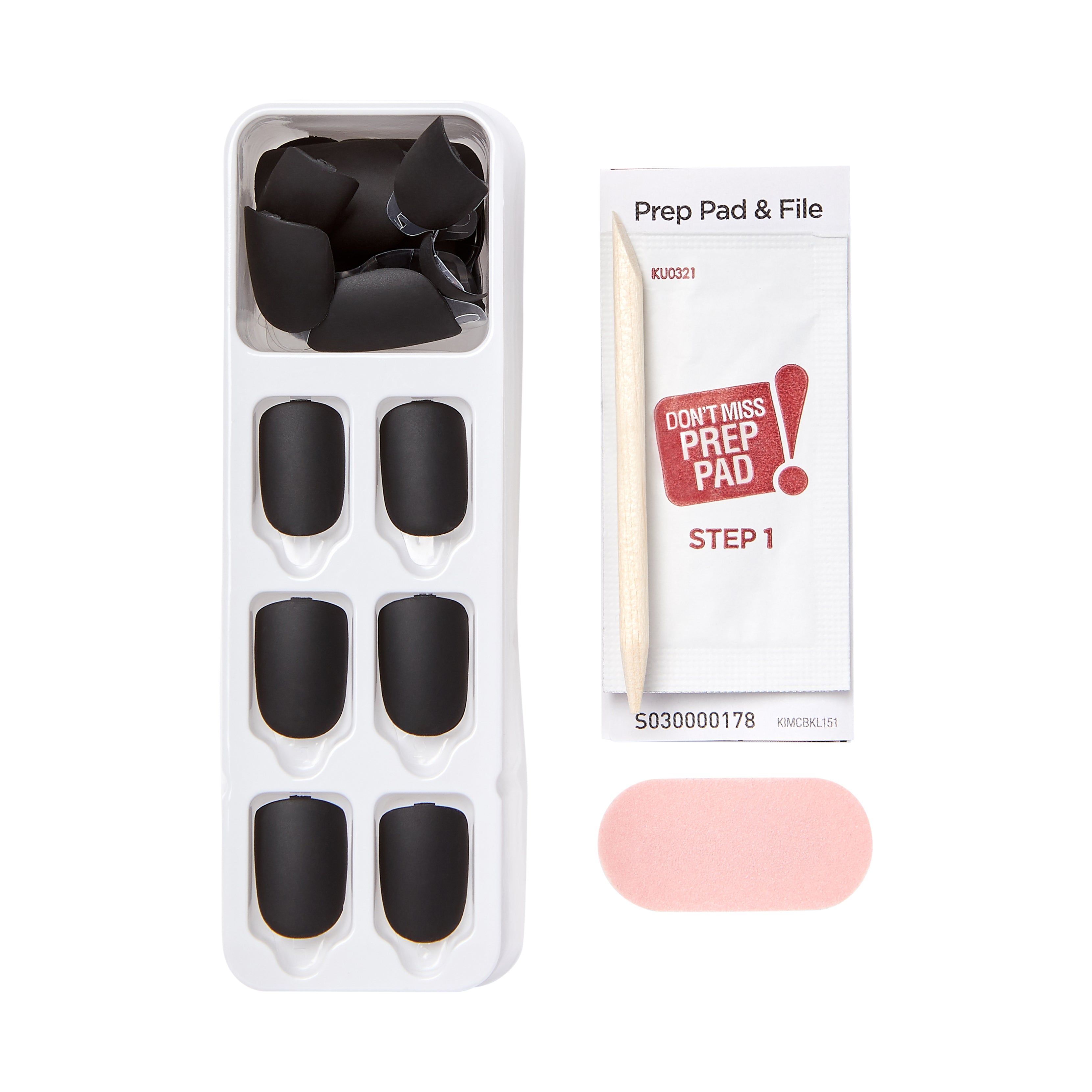 Black matte press-on nails arranged in a white tray along with a wooden cuticle stick, a pink nail file, and a prep pad packet labeled “Don’t Miss Prep Pad Step 1.”