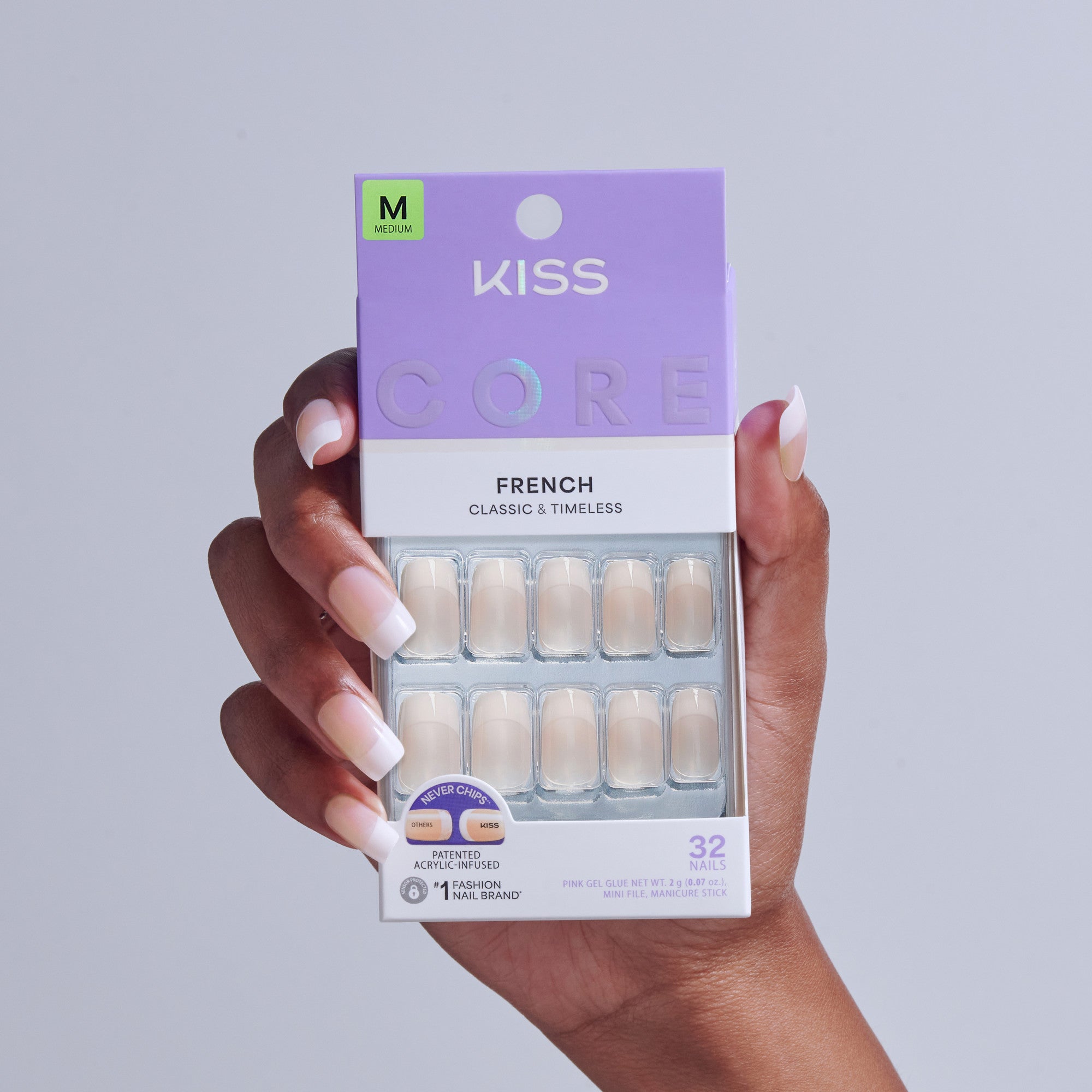 KISS CORE French fake nails in Medium size, displayed in packaging held by hand.