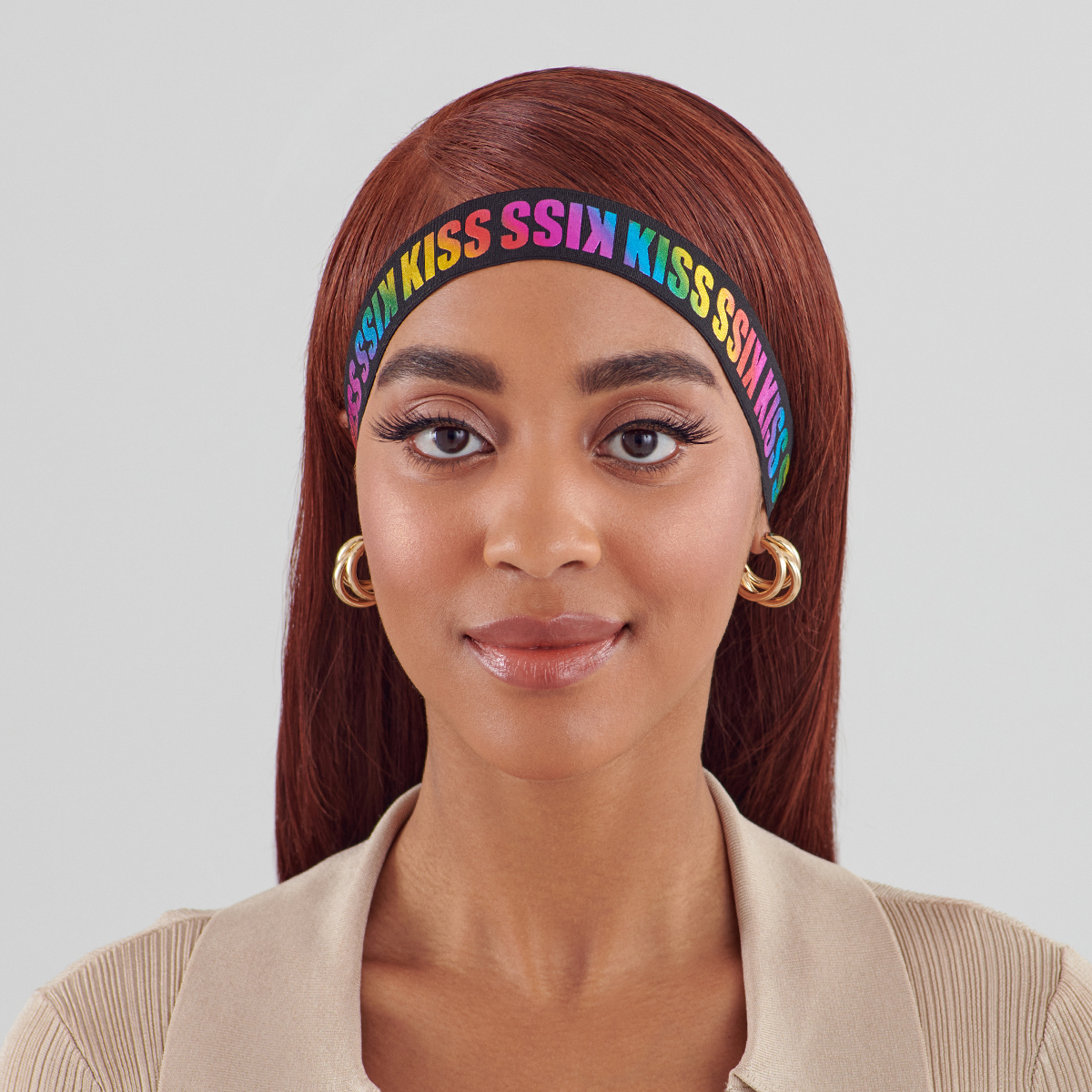 Woman with straight reddish-brown hair wears a black elastic headband with repeating \