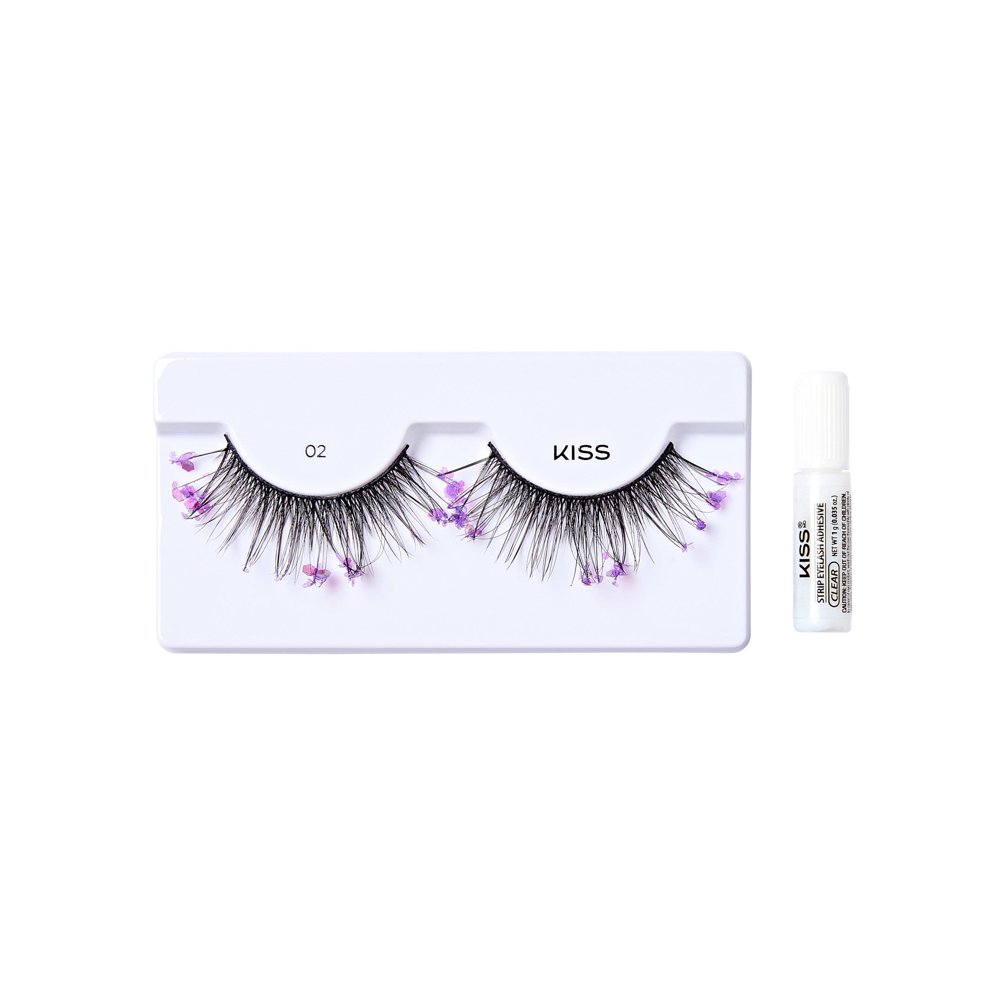 The image shows a set of false eyelashes from the brand "KISS." The eyelashes are displayed on a white plastic holder labeled with the number "02." The lashes are black and have small, delicate purple flowers attached to them, adding a decorative touch. To the right of the eyelashes, there is a small white tube of adhesive glue, also branded with "KISS" and labeled as "Strip Eyelash Adhesive." The overall presentation is clean and minimalistic, highlighting the product&