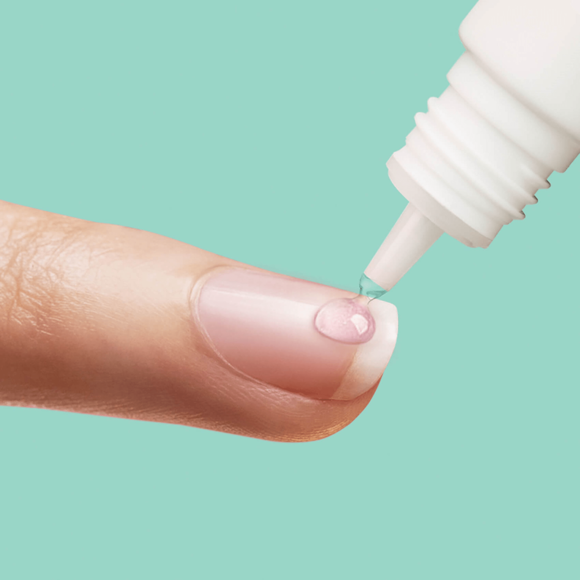 Close-up of a finger with a clear drop of nail glue being applied from a white precision tip bottle against a mint green background.
