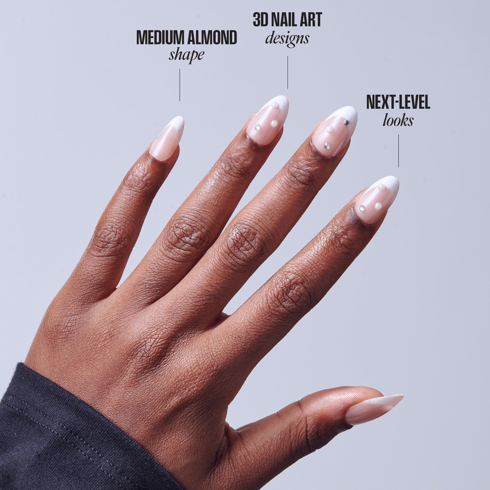 Medium almond 3D nail art with white tips and pearl embellishments on deep skin tone.
