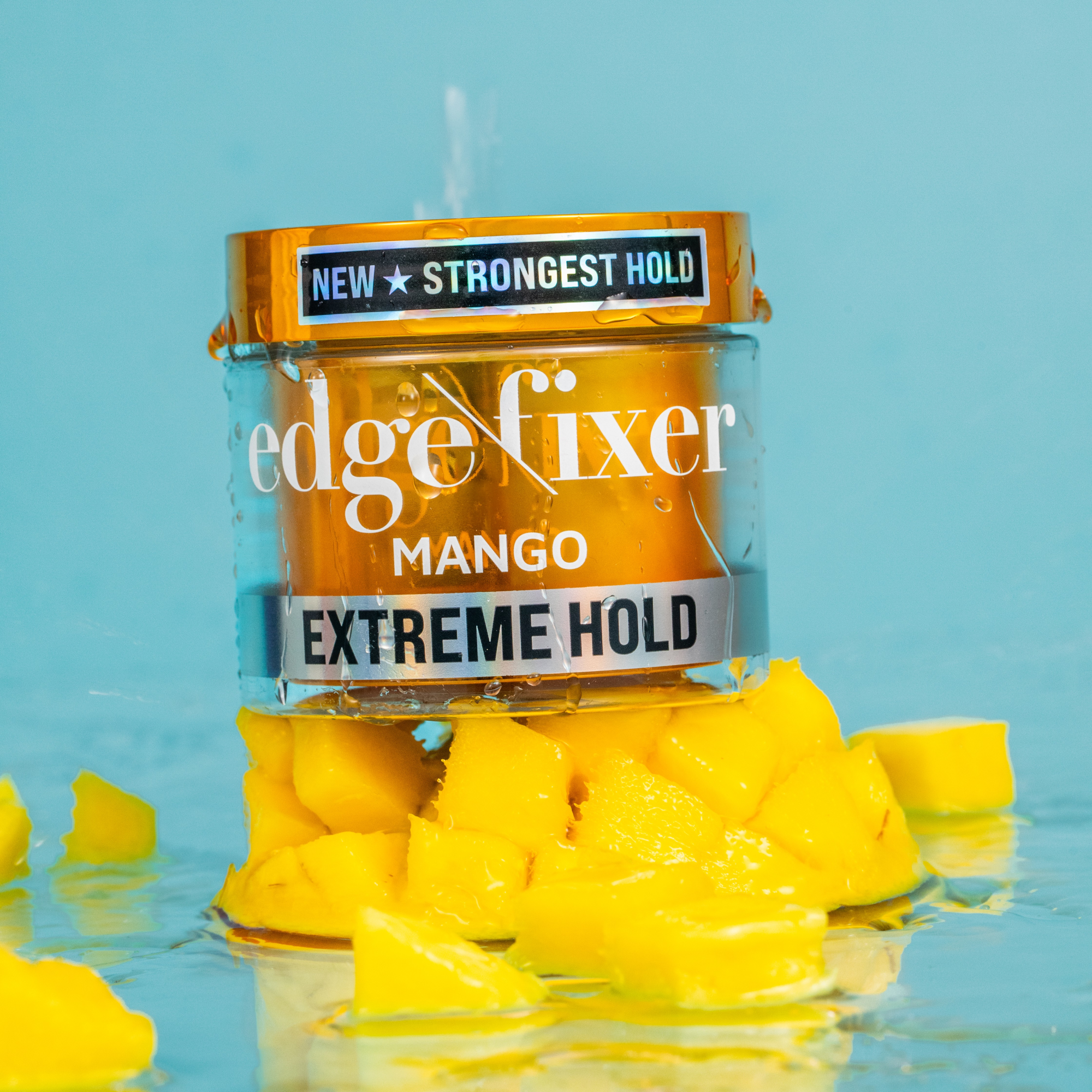Clear and orange jar of KISS Colors & Care Edge Fixer Mango Extreme Hold gel on cubed mango pieces, labeled "New Strongest Hold."