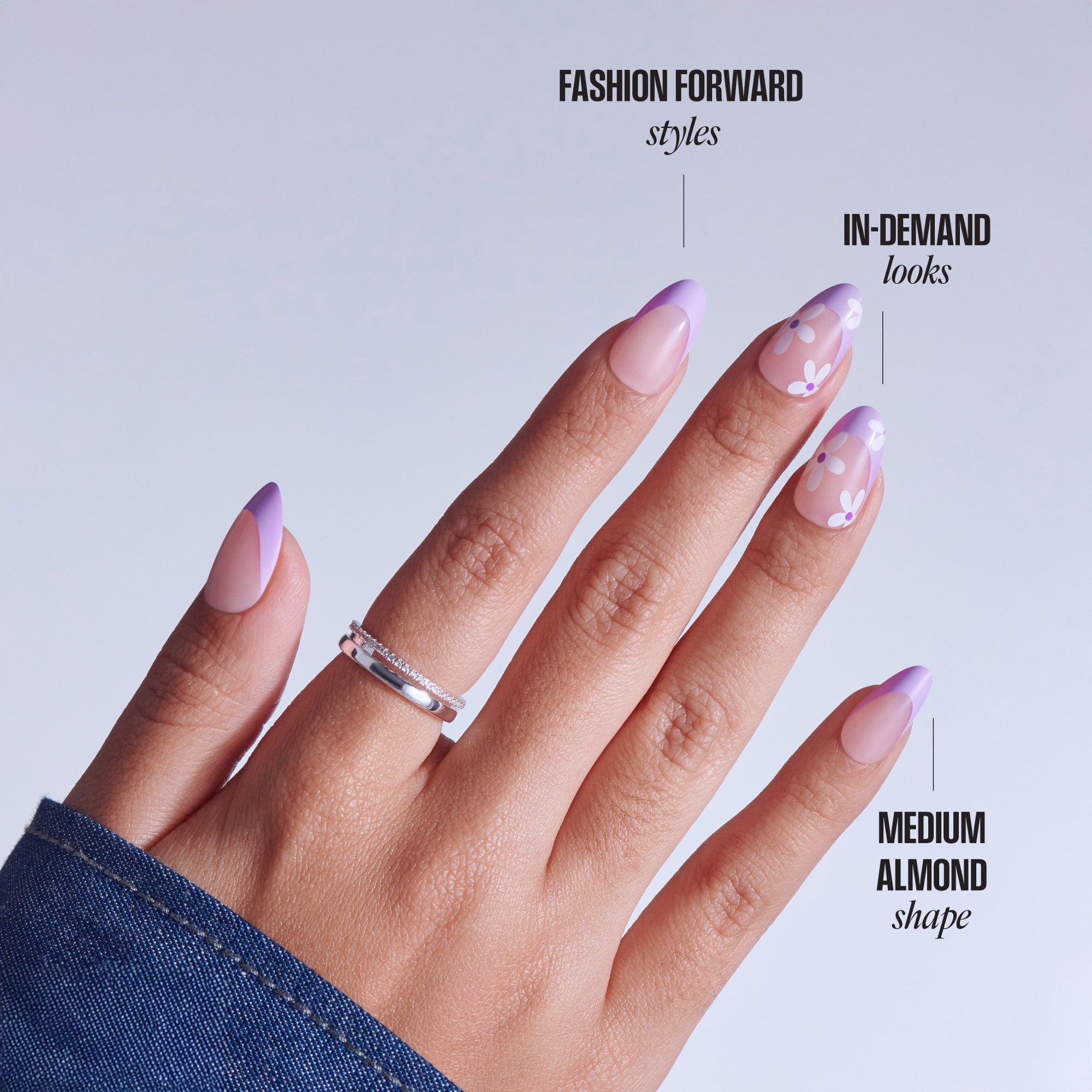 Medium almond nails with purple ombre tips and floral design details.