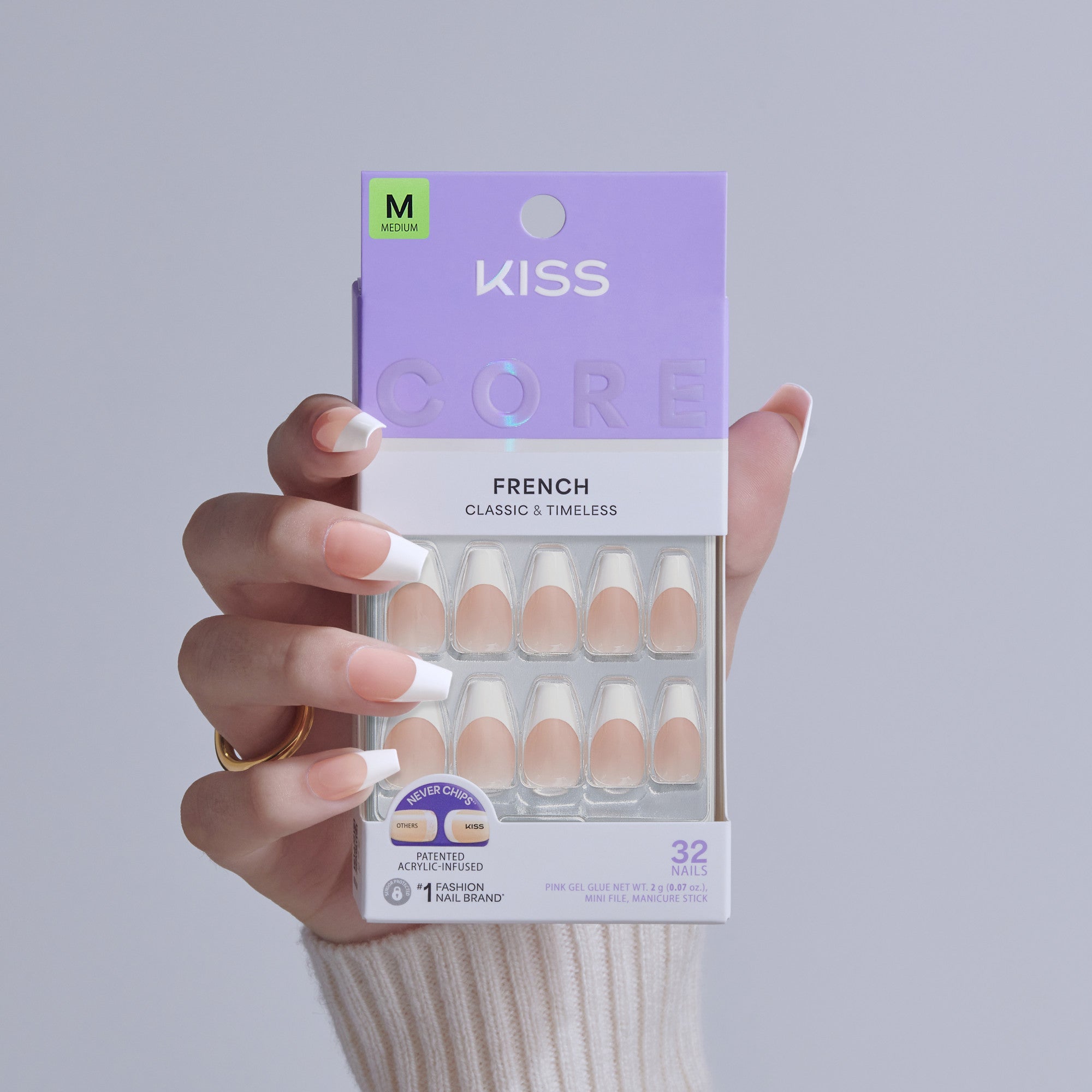 KISS Core French Classic & Timeless Medium Fake Nails in packaging held by hand