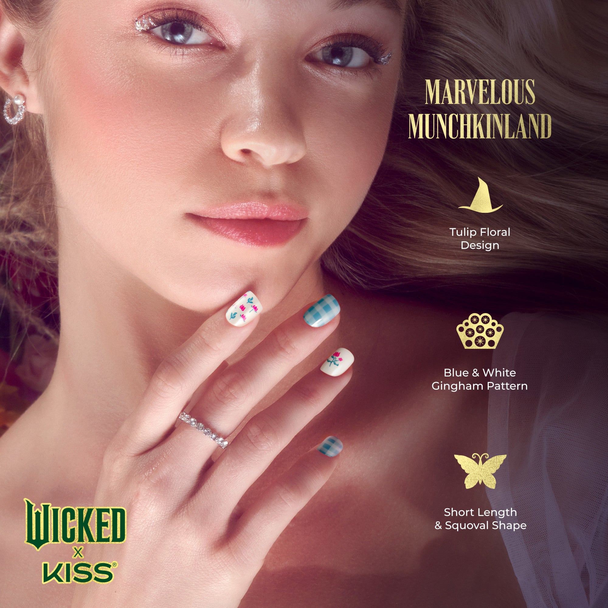 Close-up of a woman with a clear complexion showcasing short, squoval-shaped nails featuring a Marvelous Munchkinland design with tulip floral and blue & white gingham patterns. Text highlights nail art details and brand Wicked x Kiss.