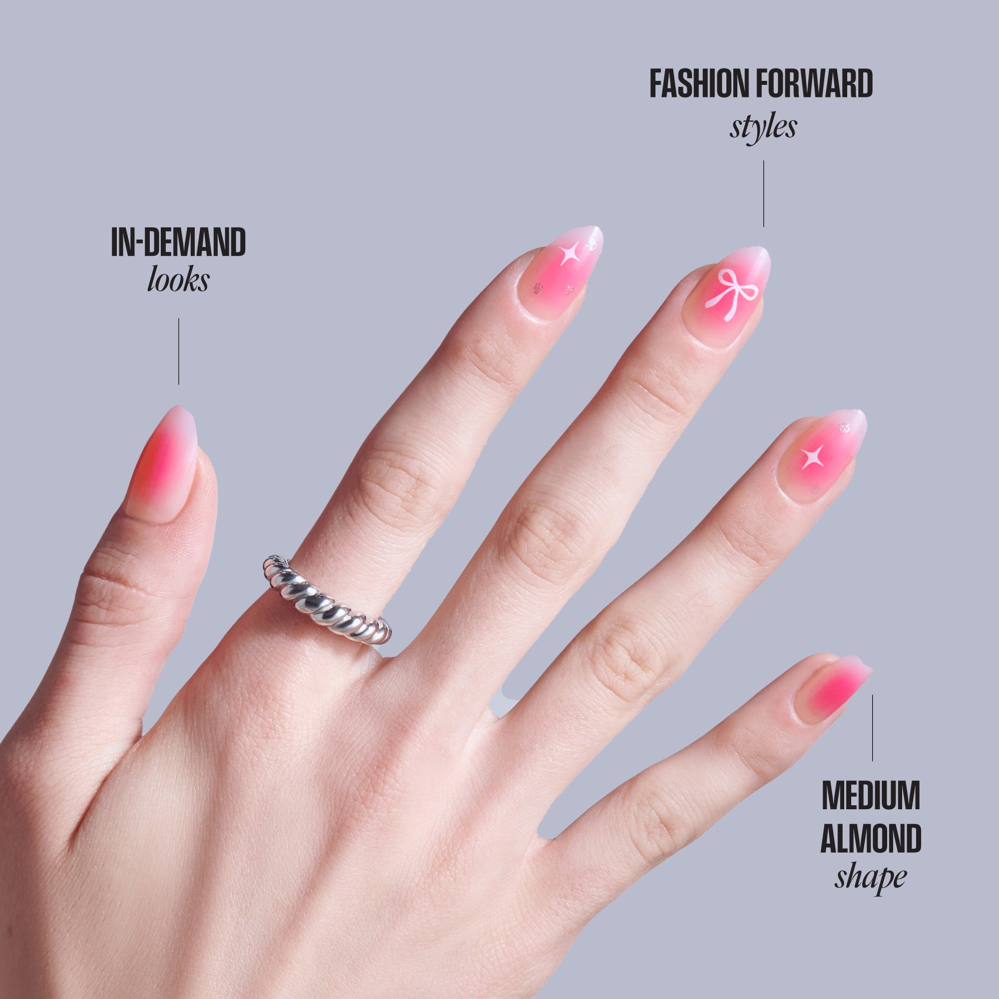 Pink ombre nails with star and bow designs on medium almond shape nails.
