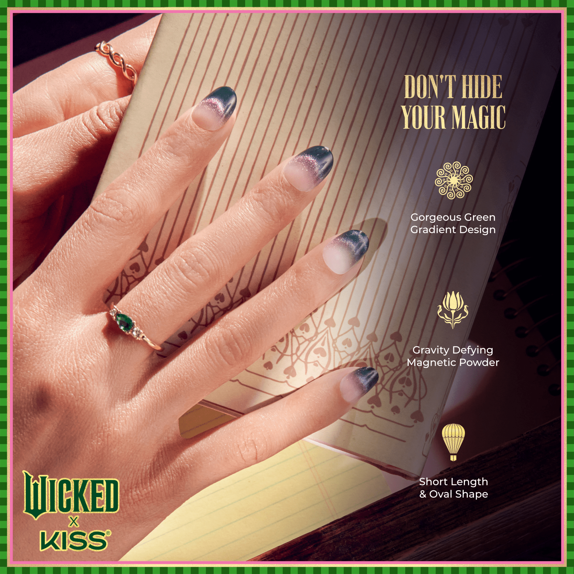 Hand with short oval nails featuring a green gradient magnetic design, wearing gold rings, resting on an open notebook. Text: \