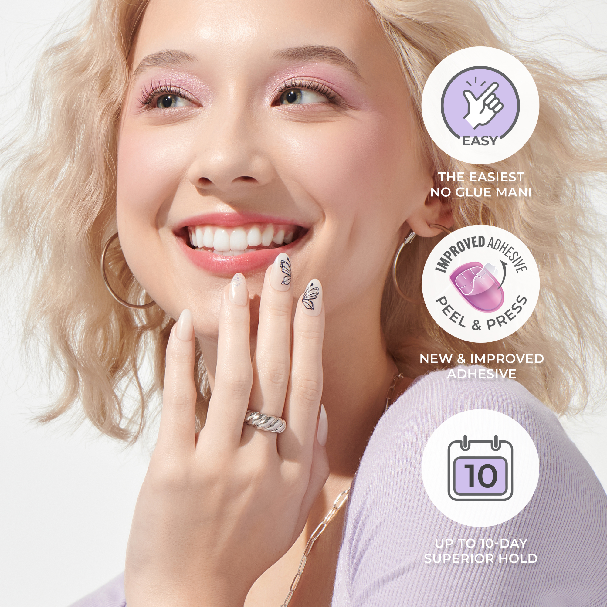 Smiling woman with light blonde hair shows almond-shaped press-on nails in nude with black butterfly and glitter accents, highlighting easy no-glue application, improved adhesive, and up to 10-day hold.