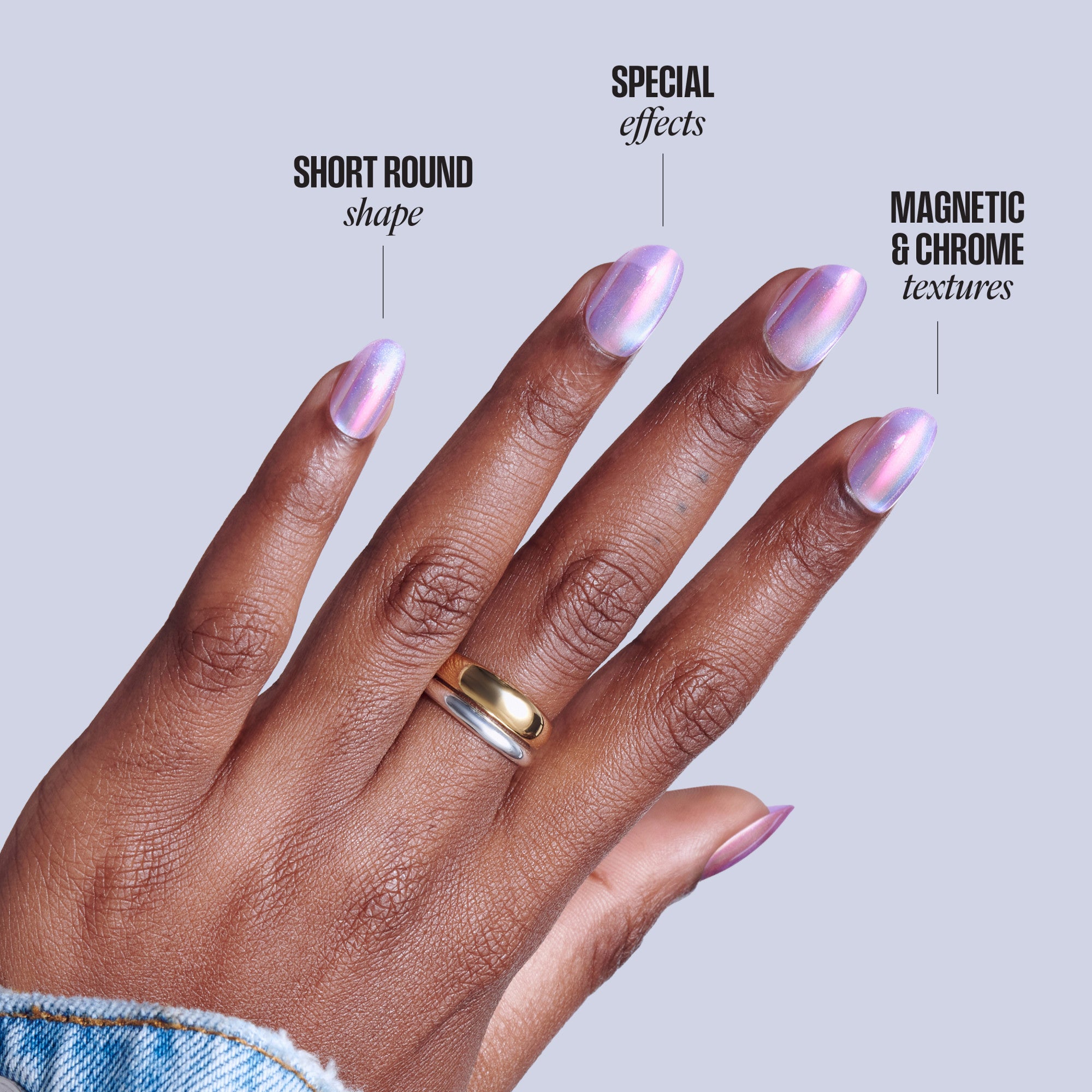Hand displaying short round nails with iridescent purple chrome finish and magnetic textures.
