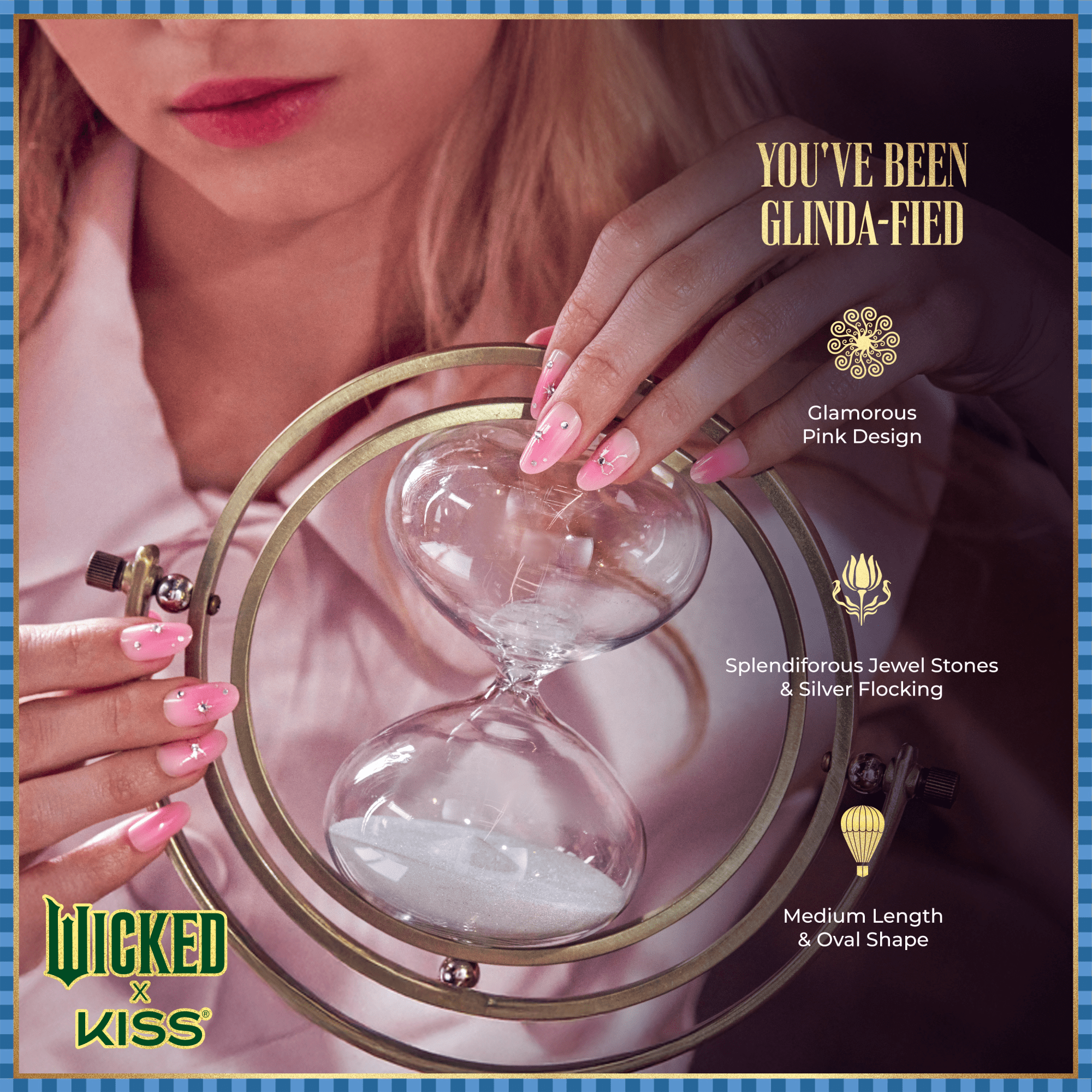 Close-up of hands with medium-length, oval-shaped pink nails adorned with jewel stones and silver flocking, holding a decorative hourglass.