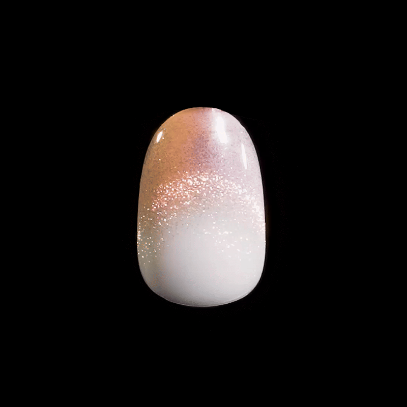 Artificial nail tip featuring a gradient design with sparkly pink and white colors on a glossy finish, shown against a black background.