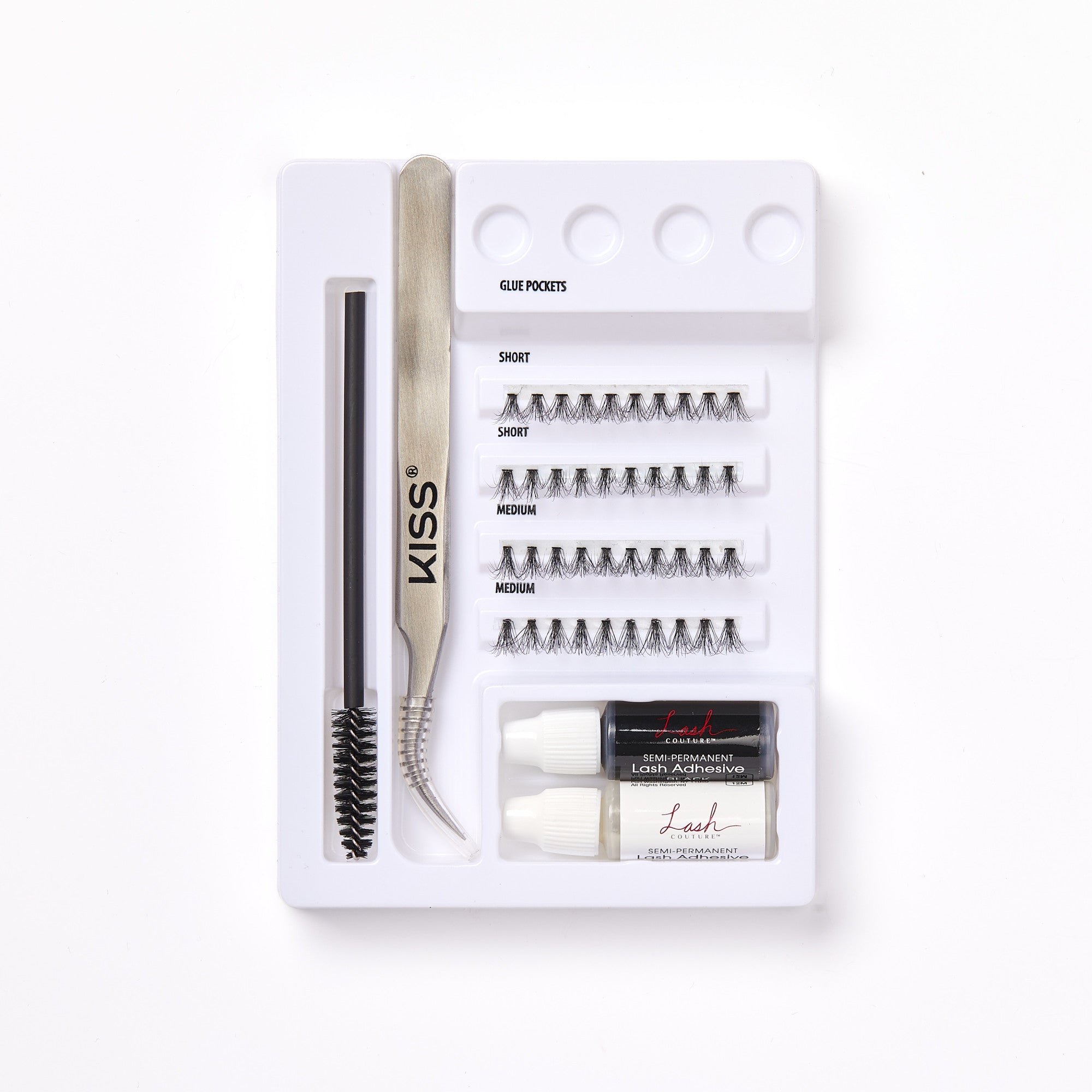 KISS Lash Couture Luxtensions Kit with short and medium lash clusters, black and white semi-permanent lash adhesive, curved tweezers, and a lash spoolie on a white tray.