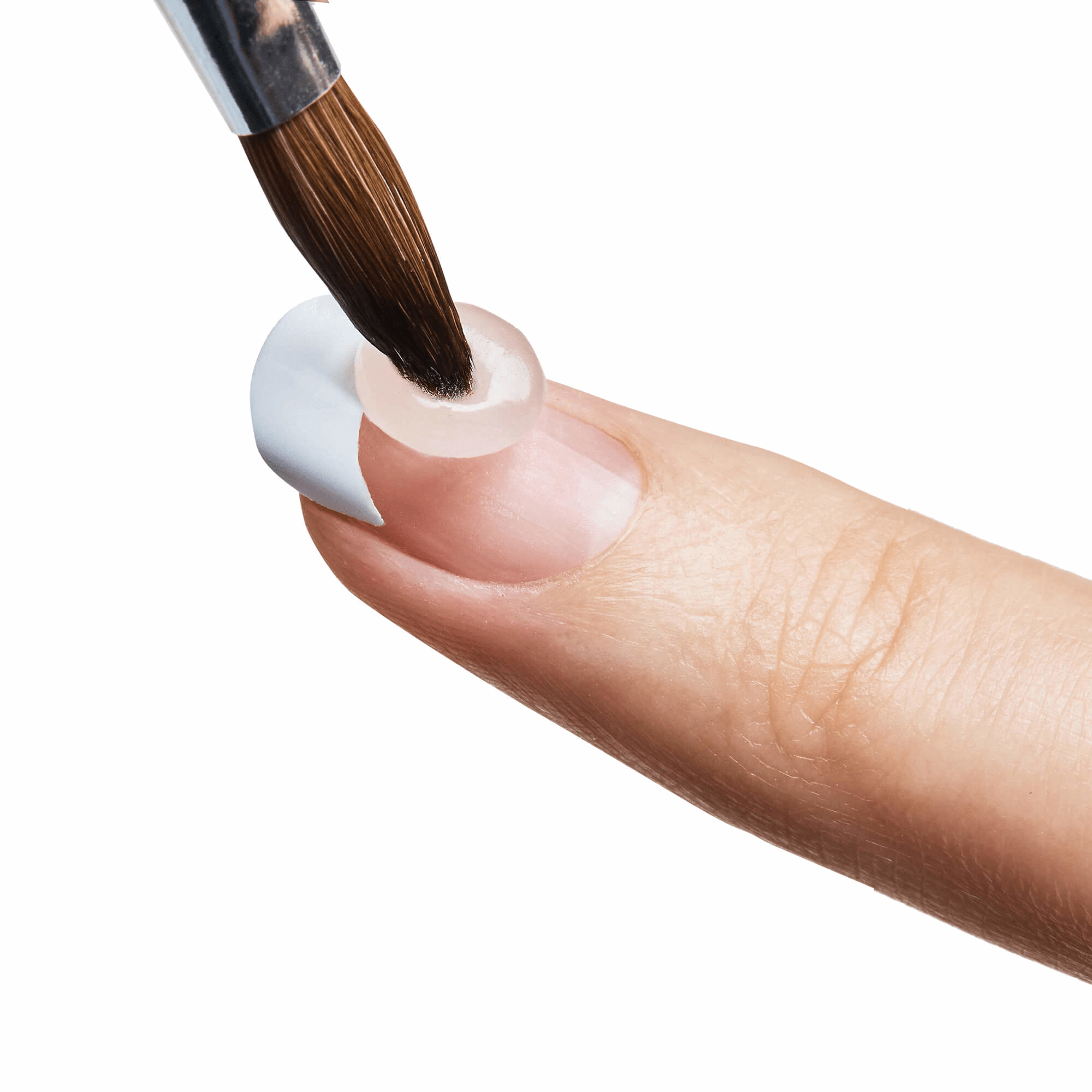 Close-up of a finger with a natural nail tip applied, showing a brush applying clear acrylic gel onto the edge for French manicure styling.