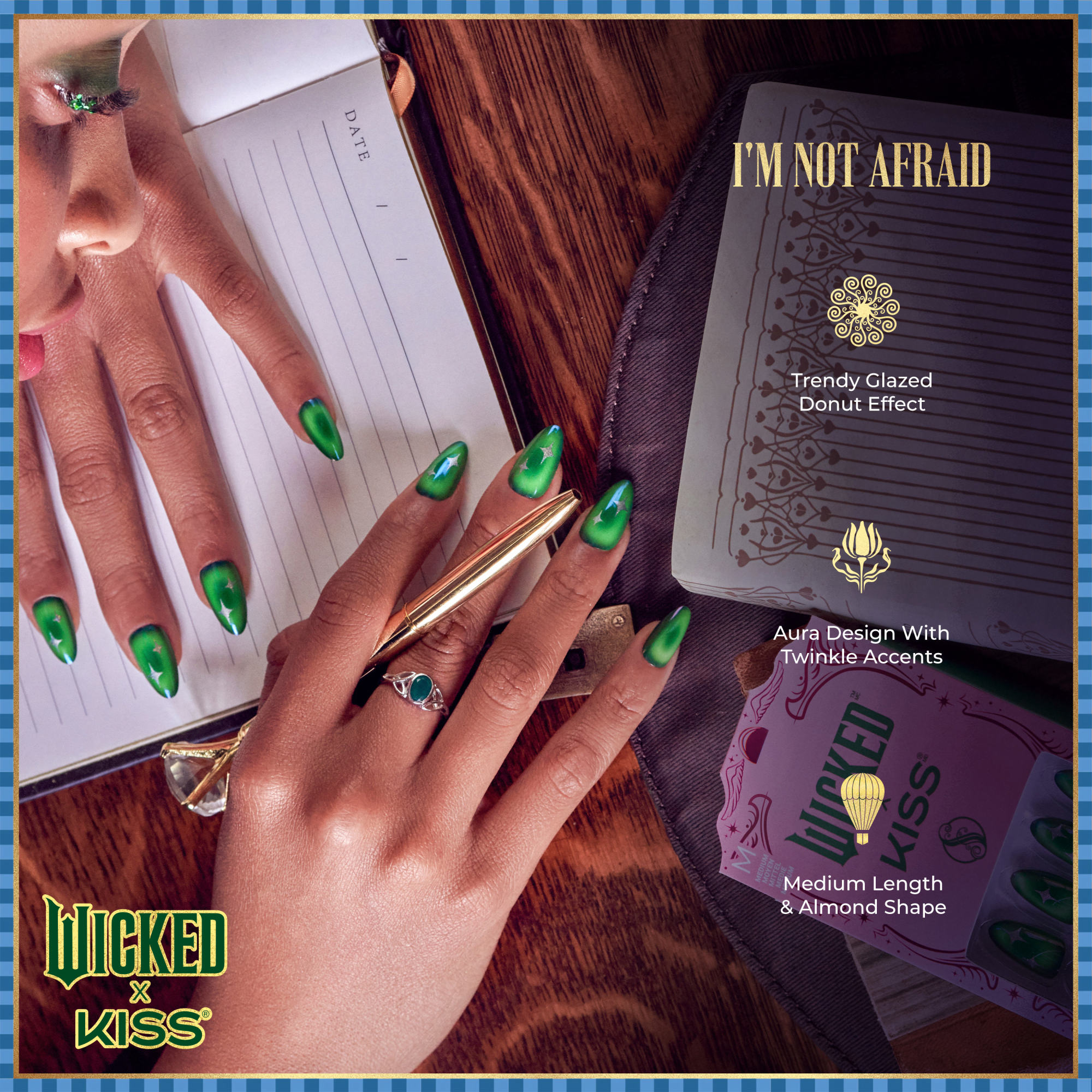 Hands with medium-length almond-shaped nails painted in green with a trendy glazed donut effect and twinkle accents, shown over a wood table and open notebook. Text highlights “I’m Not Afraid” design features.