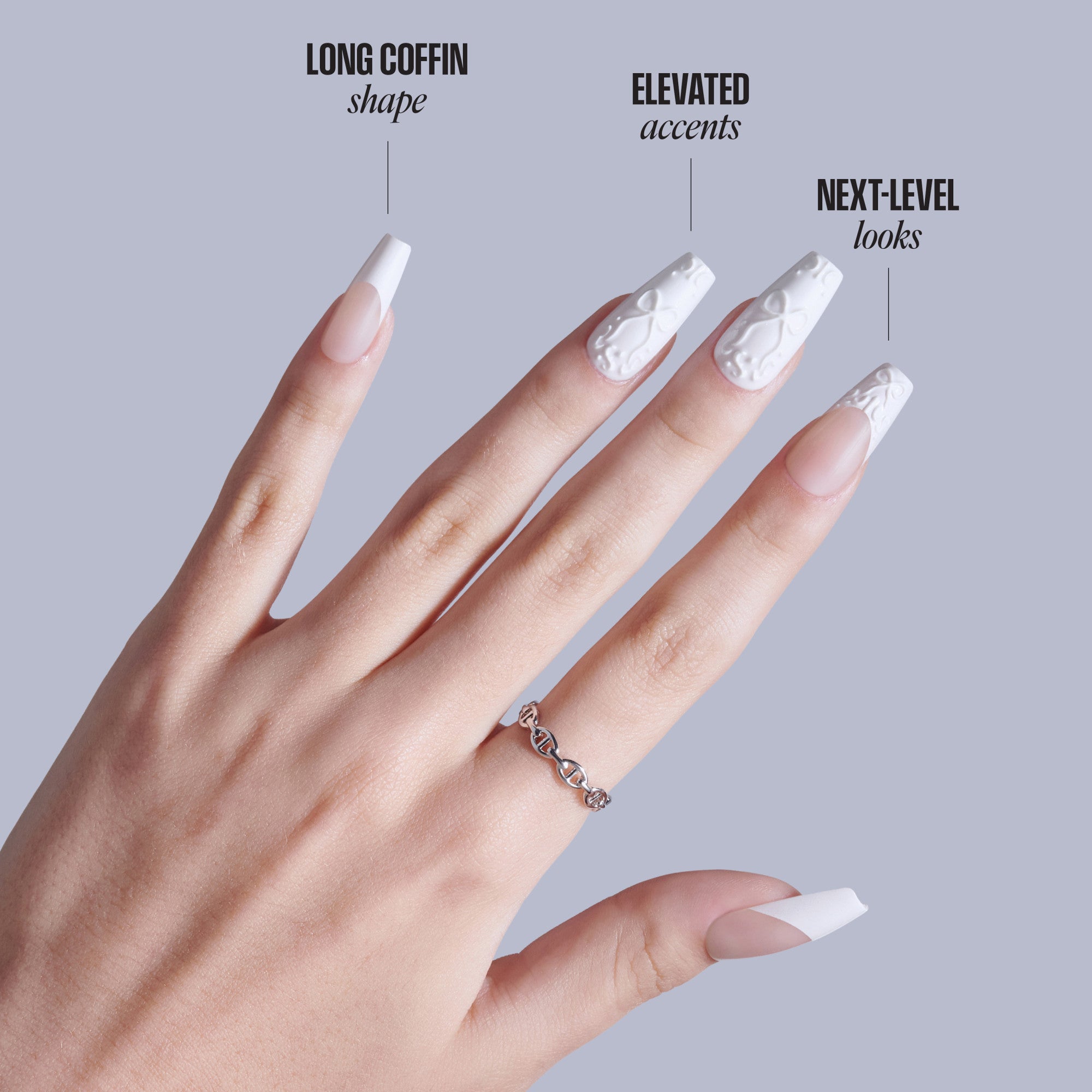 Long coffin nail shapes with white tips, elevated accents, and next-level designs displayed on hand.