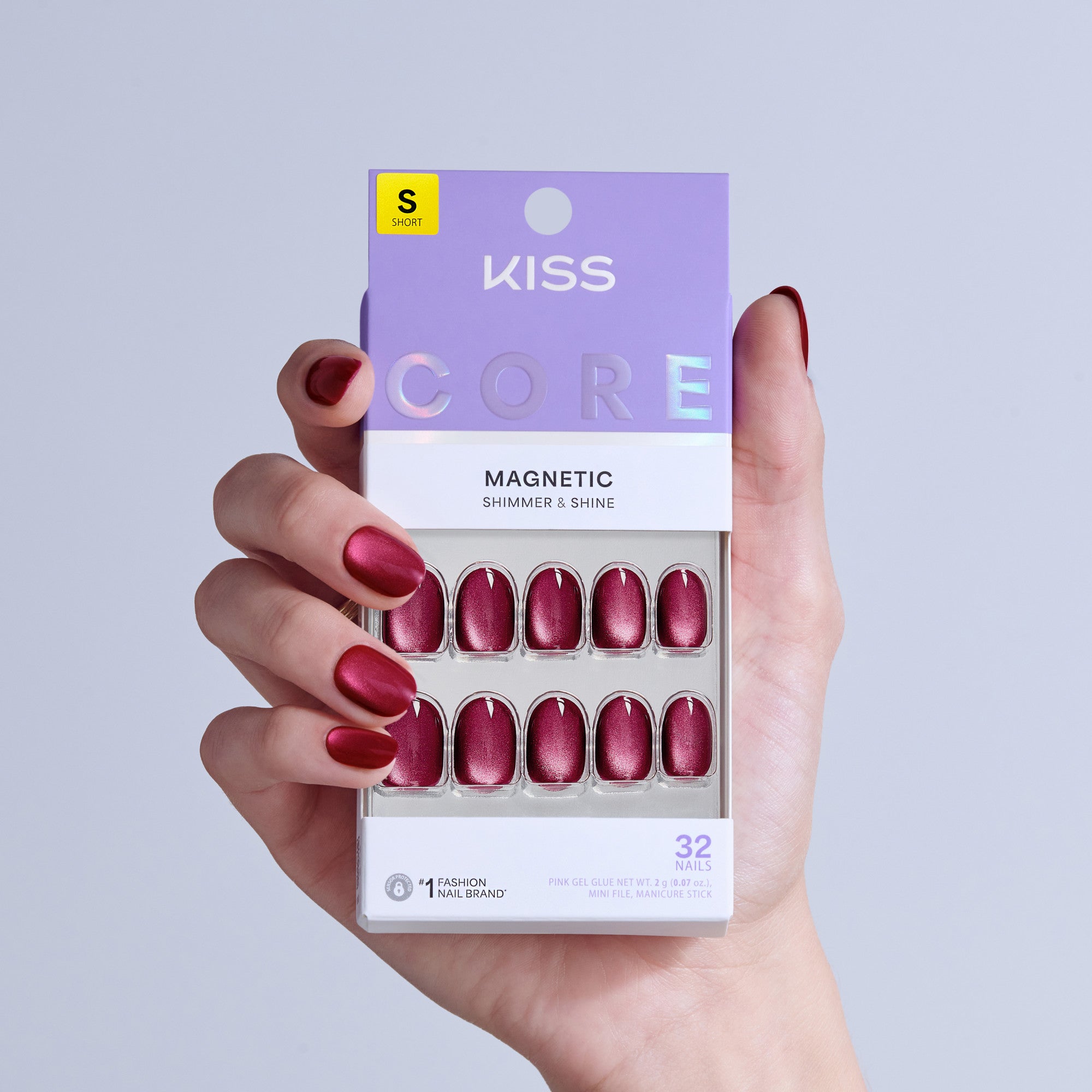 KISS Core Magnetic press-on nails in burgundy shimmer, size short, 32 nails displayed in packaging.