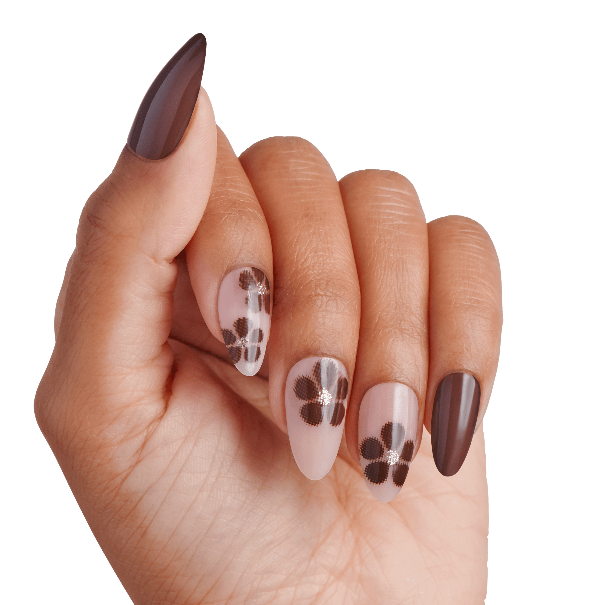 The image features a hand displaying a stylish manicure with a mix of nail designs. The nails are shaped into a pointed almond style. The color palette includes rich brown shades and soft nude tones. Some nails are adorned with elegant floral designs in darker hues, while others are a solid brown. The overall look is chic and modern, showcasing a blend of simplicity and artistic flair.