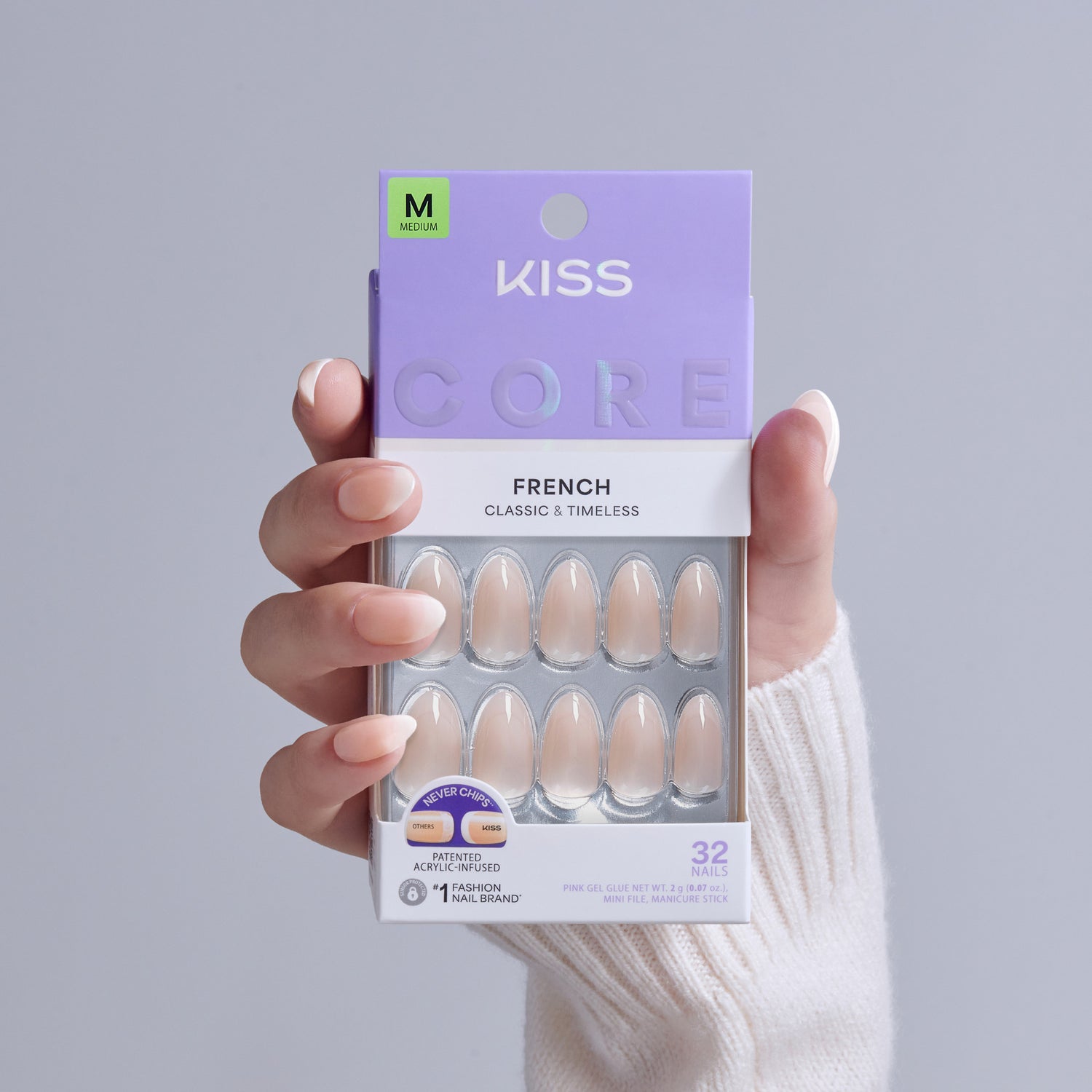 KISS Core French nails, medium size, 32 classic nude press-on nails in packaging held by hand.