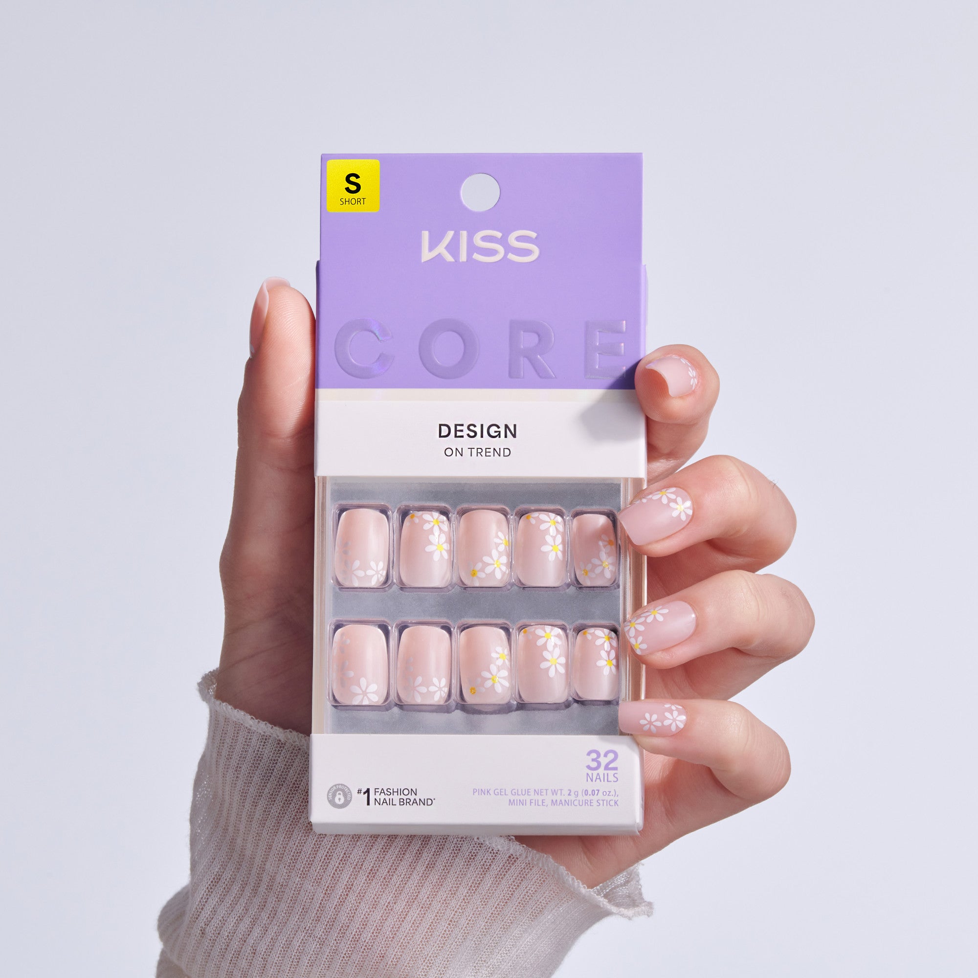 KISS Core Design press-on nails in short size with daisy floral pattern on pink base.