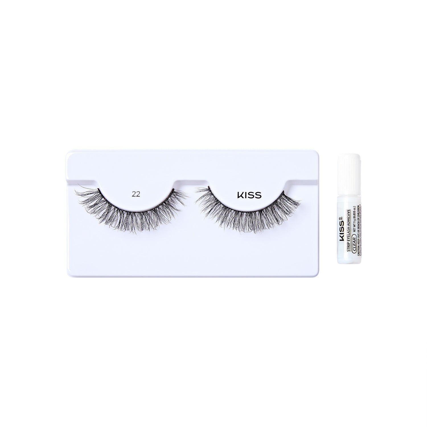 The image shows a set of false eyelashes from the brand "KISS." The eyelashes are displayed on a white plastic holder, with the number "22" printed above the left eyelash. To the right of the holder, there is a small tube of adhesive glue, also branded with "KISS." The eyelashes are voluminous and appear to be designed for a dramatic look.