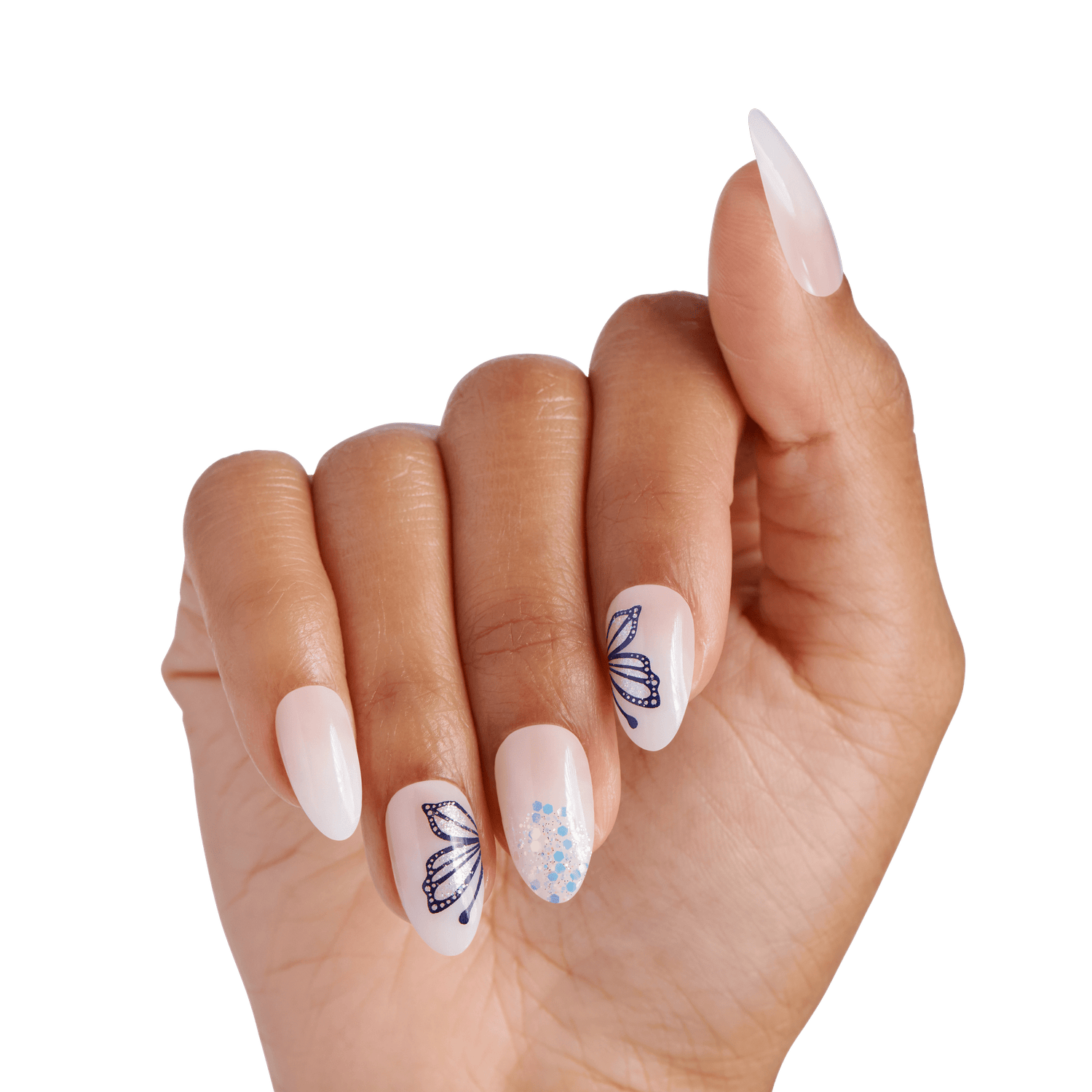 The image features a hand with elegantly manicured nails. The nails are a mix of a glossy nude shade and a white base, adorned with intricate butterfly designs in a deep blue color. One nail showcases a sparkling design with small, shimmering gems, adding a touch of glamour. The overall look is stylish and sophisticated, highlighting the artistry of nail design.