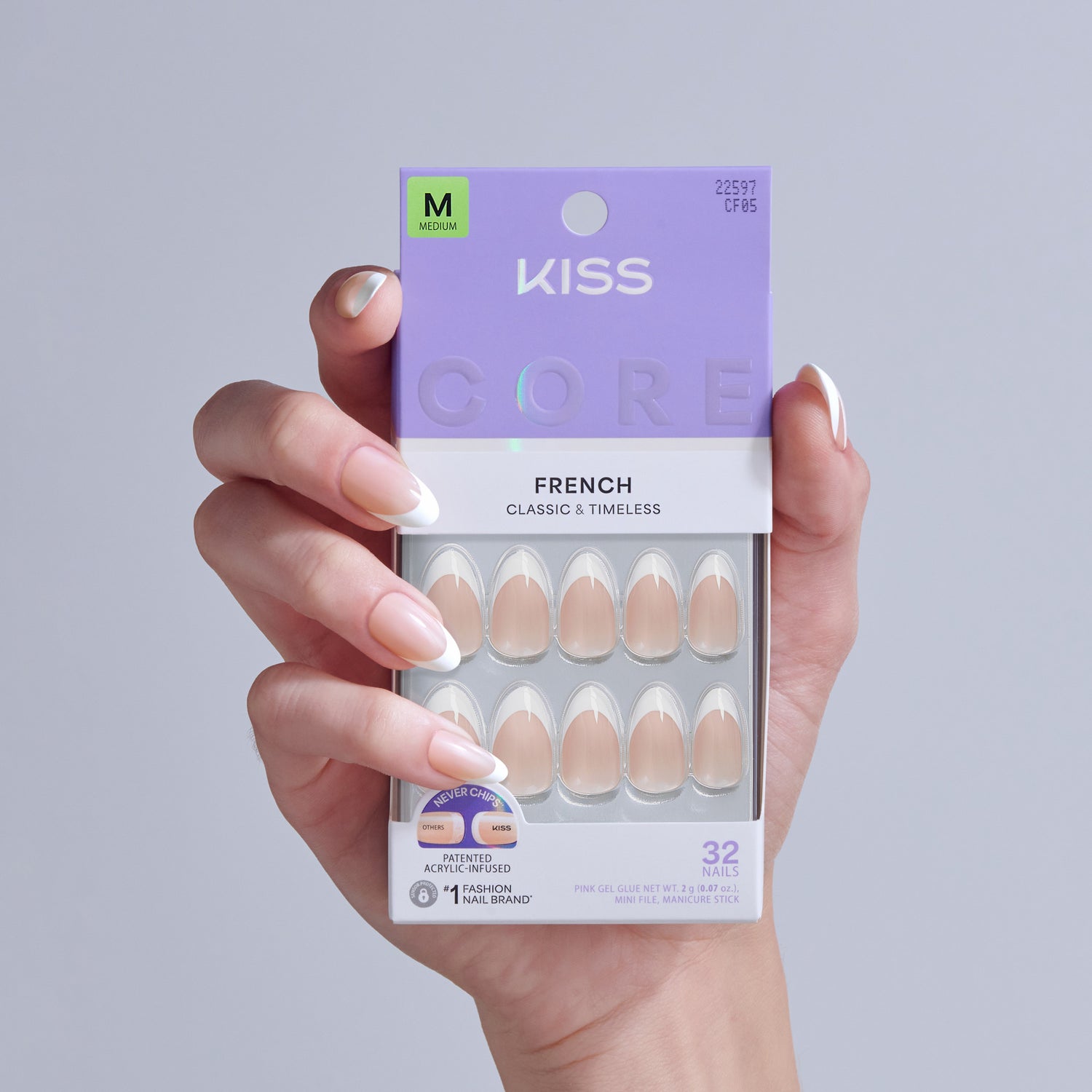 KISS Core French Classic &amp; Timeless fake nails in Medium size, displayed on a hand showing the manicure style.