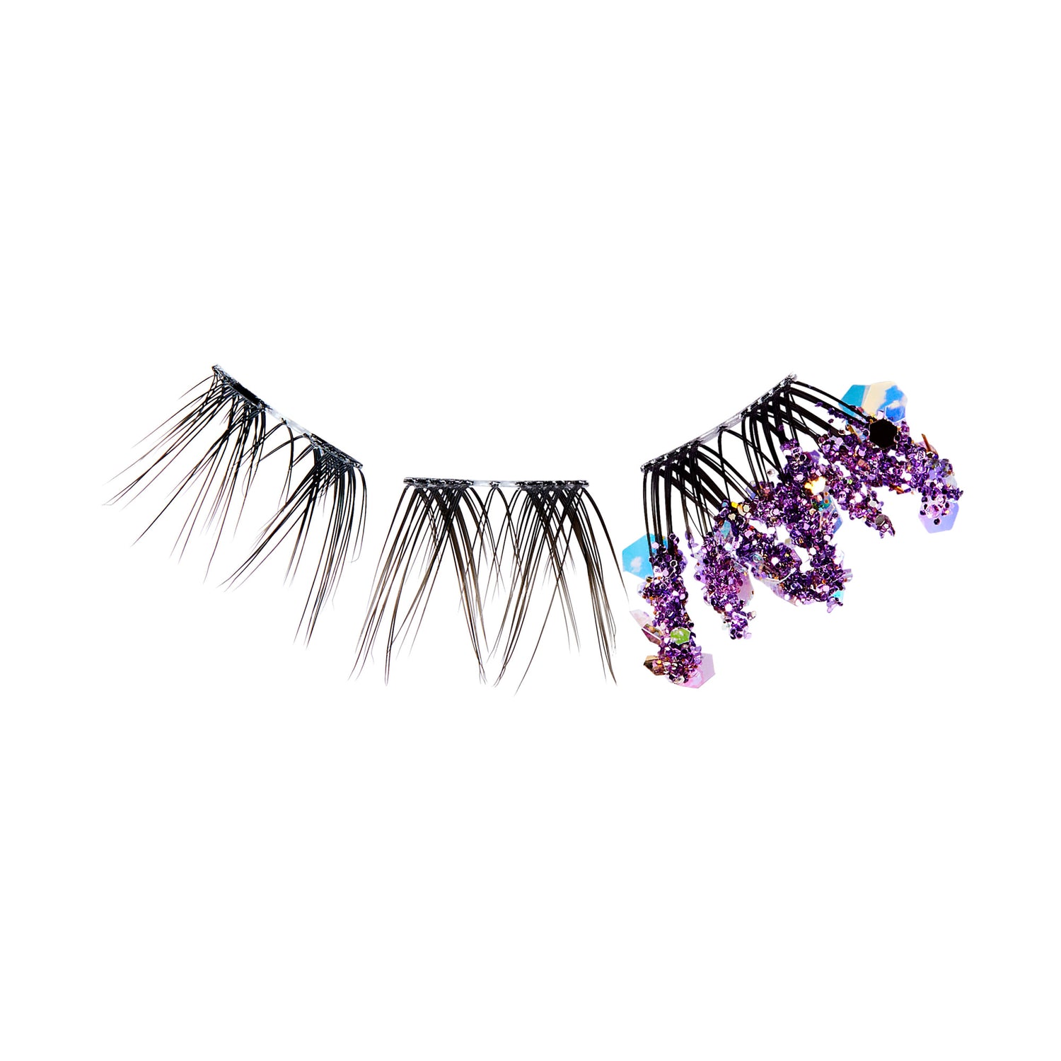 The image features a set of false eyelashes that are designed with a unique and artistic flair. The lashes are predominantly black, with varying lengths that create a dramatic effect. On one end, the lashes are adorned with clusters of purple flowers, adding a vibrant and whimsical touch. The overall design combines elegance with a playful aesthetic, making it suitable for special occasions or creative makeup looks.