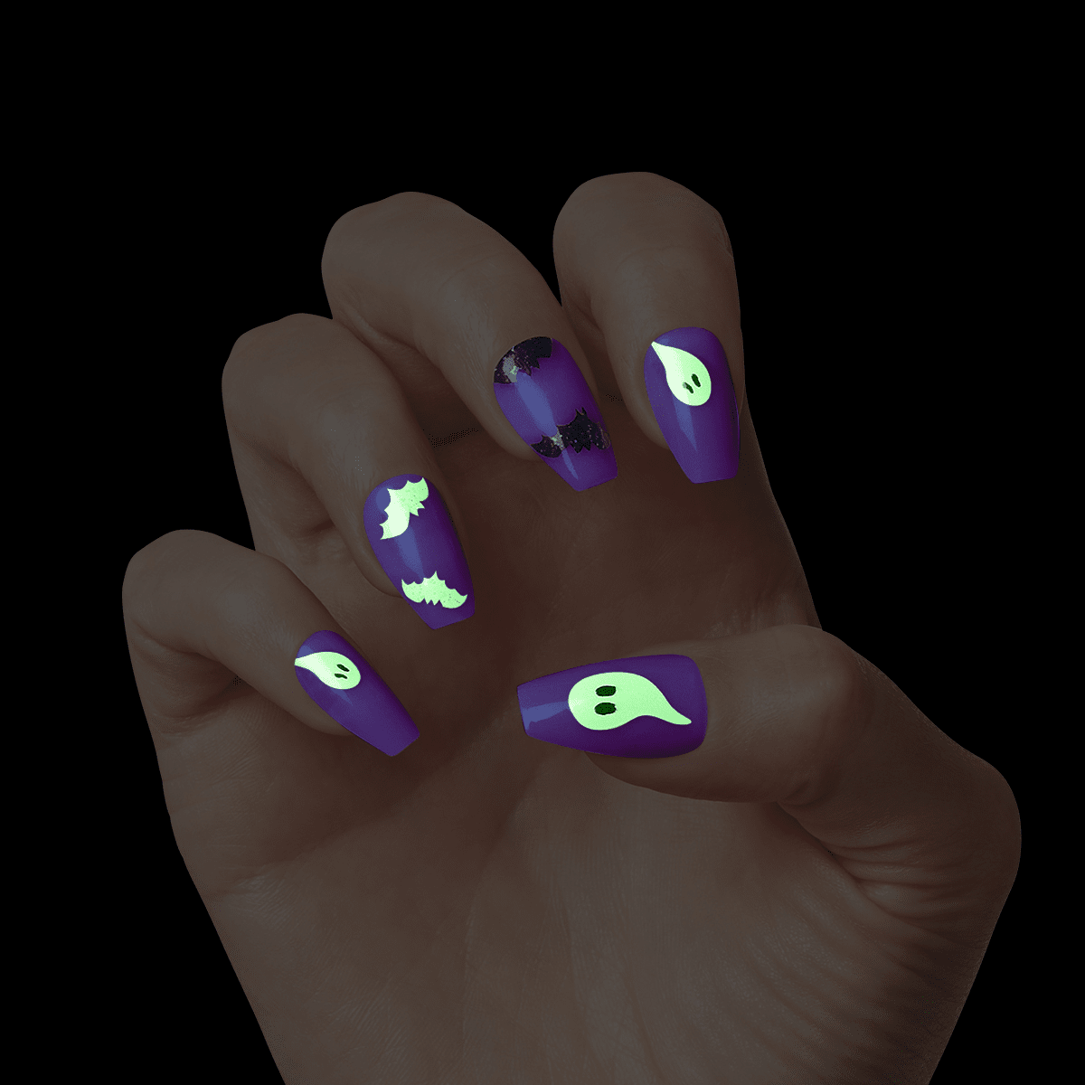 Hand with purple, glow-in-the-dark Halloween press-on nails featuring green ghosts and black bats designs on a dark background.