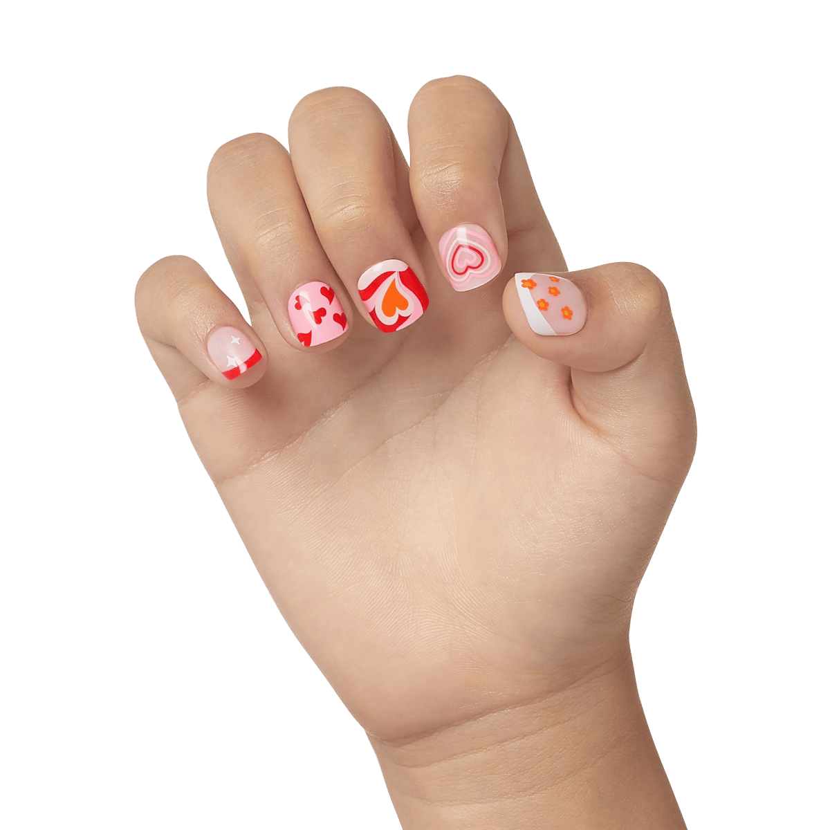 Child’s left hand showing five press-on nails with playful designs: red hearts on pink, orange and red hearts with swirls, concentric pink hearts, red tips with white stars, and orange flowers on pale pink with white tips.