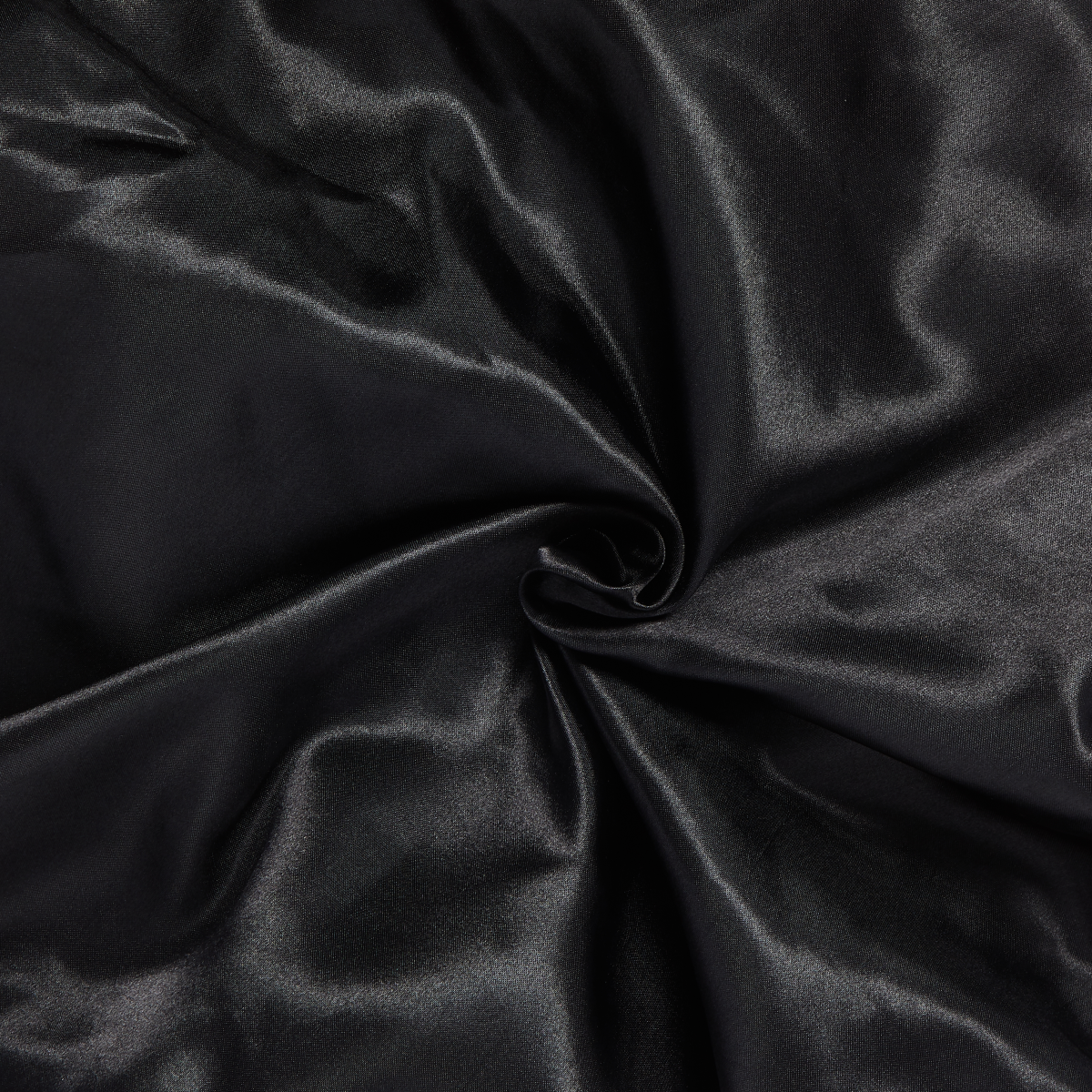 Black silky satin fabric twisted in the center, highlighting its smooth, shiny texture and soft drape.