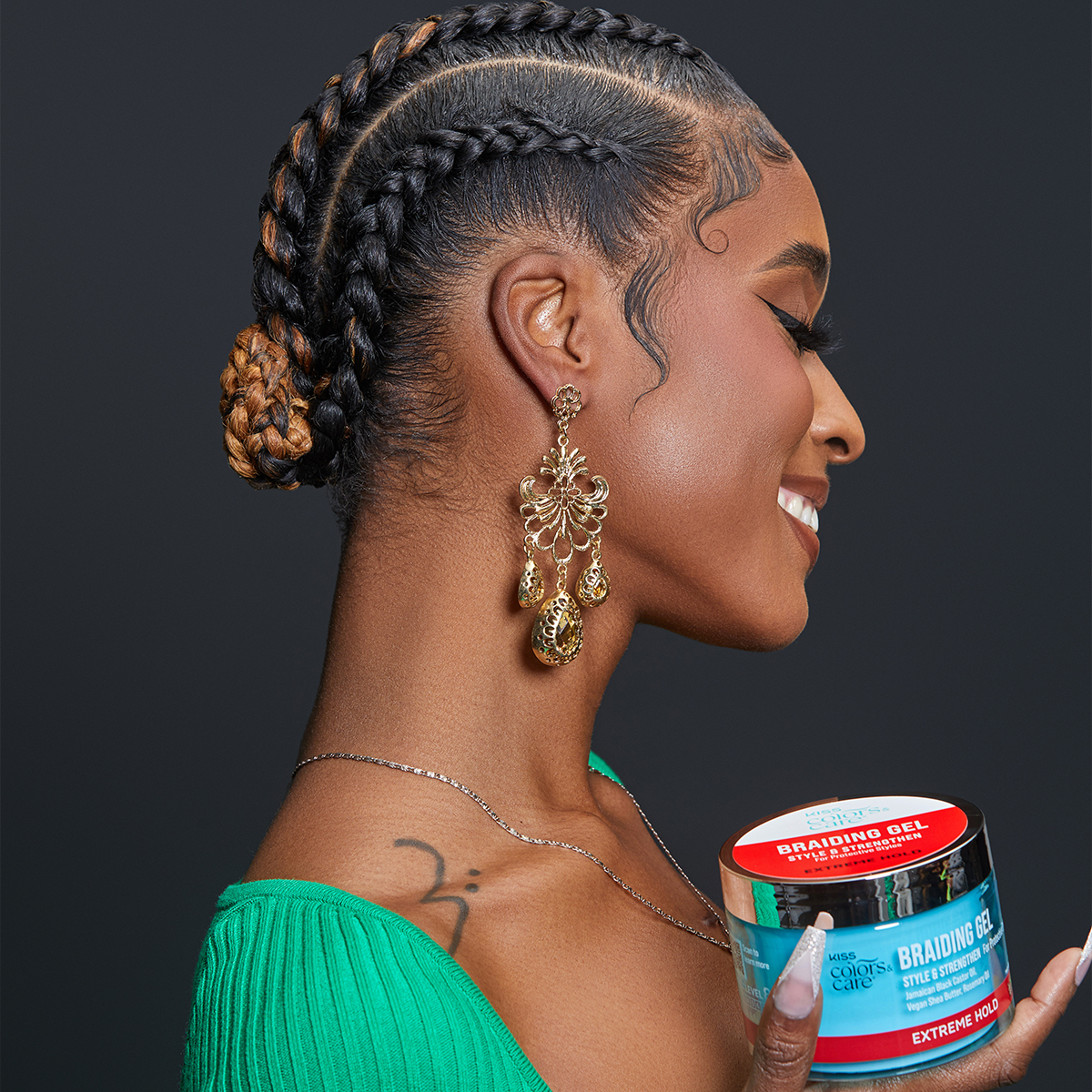 Woman with braided hair styled sleekly holds a blue jar of KISS Colors &amp; Care Braiding Gel with red label reading \