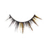 The image shows a single false eyelash. The eyelash is primarily black with a dramatic, voluminous design. It features additional decorative elements, including gold glitter and gold strands interspersed among the black lashes, giving it a striking and glamorous appearance. The lash is curved to fit the natural shape of the eyelid.