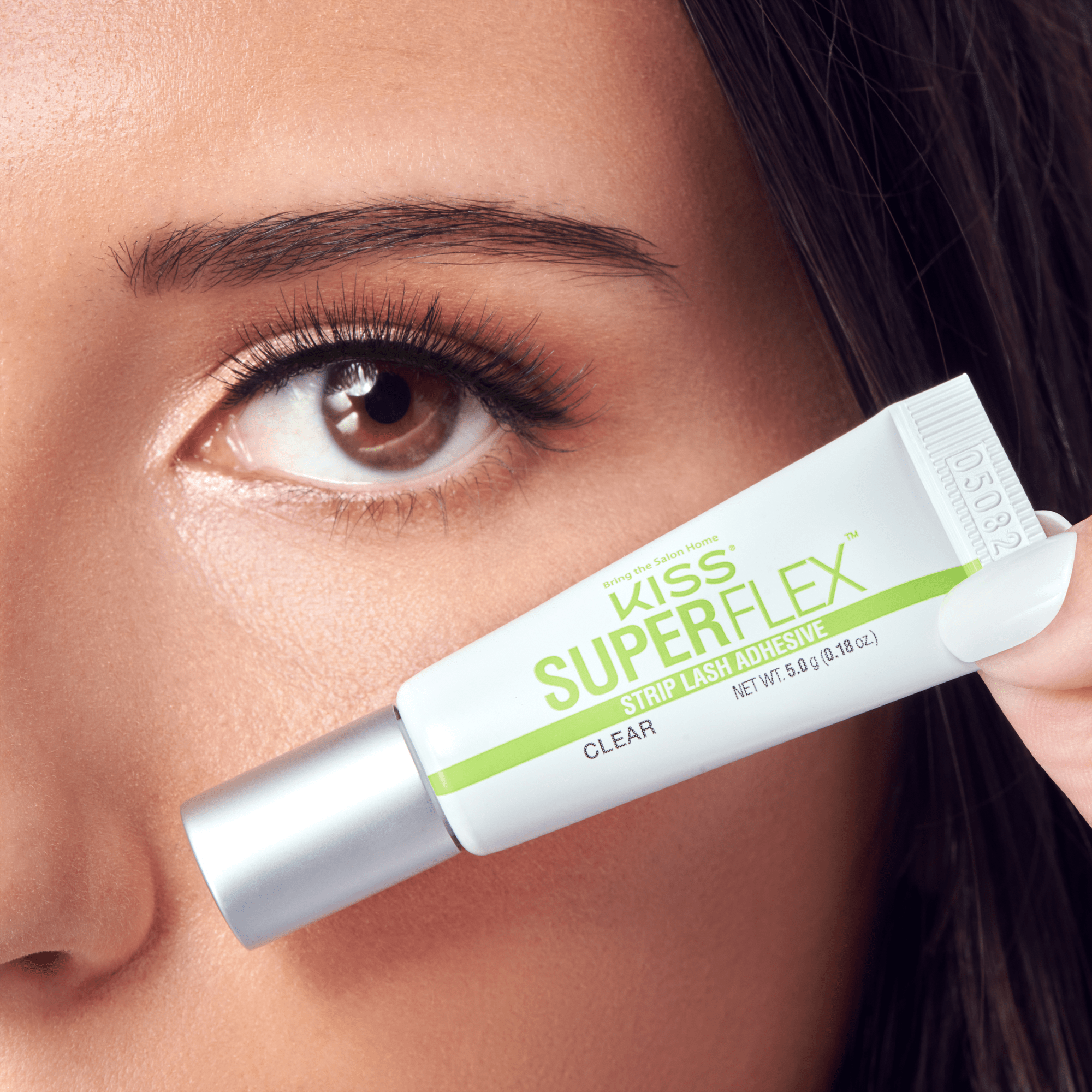 Kiss SuperFlex Clear Strip Lash Adhesive held up to model&