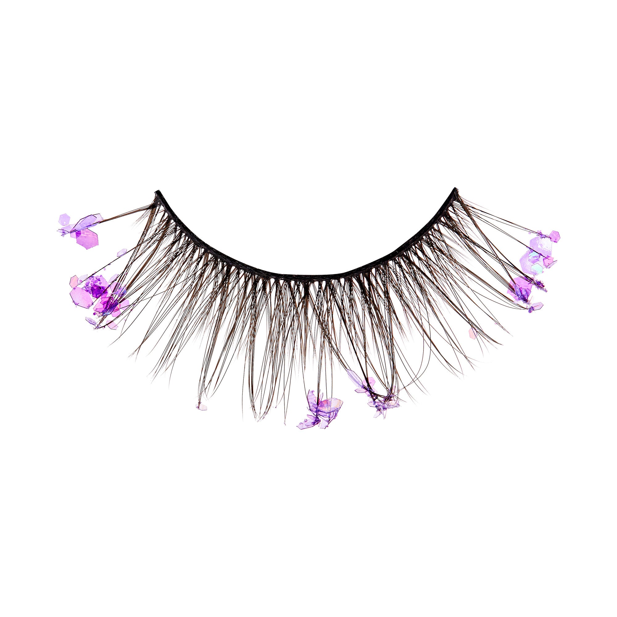 The image shows a single false eyelash strip. The eyelash strip is black and features long, wispy lashes. Attached to the lashes are small, delicate purple flowers, adding a decorative and whimsical touch to the otherwise standard false eyelash design. The flowers are spaced out along the length of the lashes, creating a unique and eye-catching appearance.