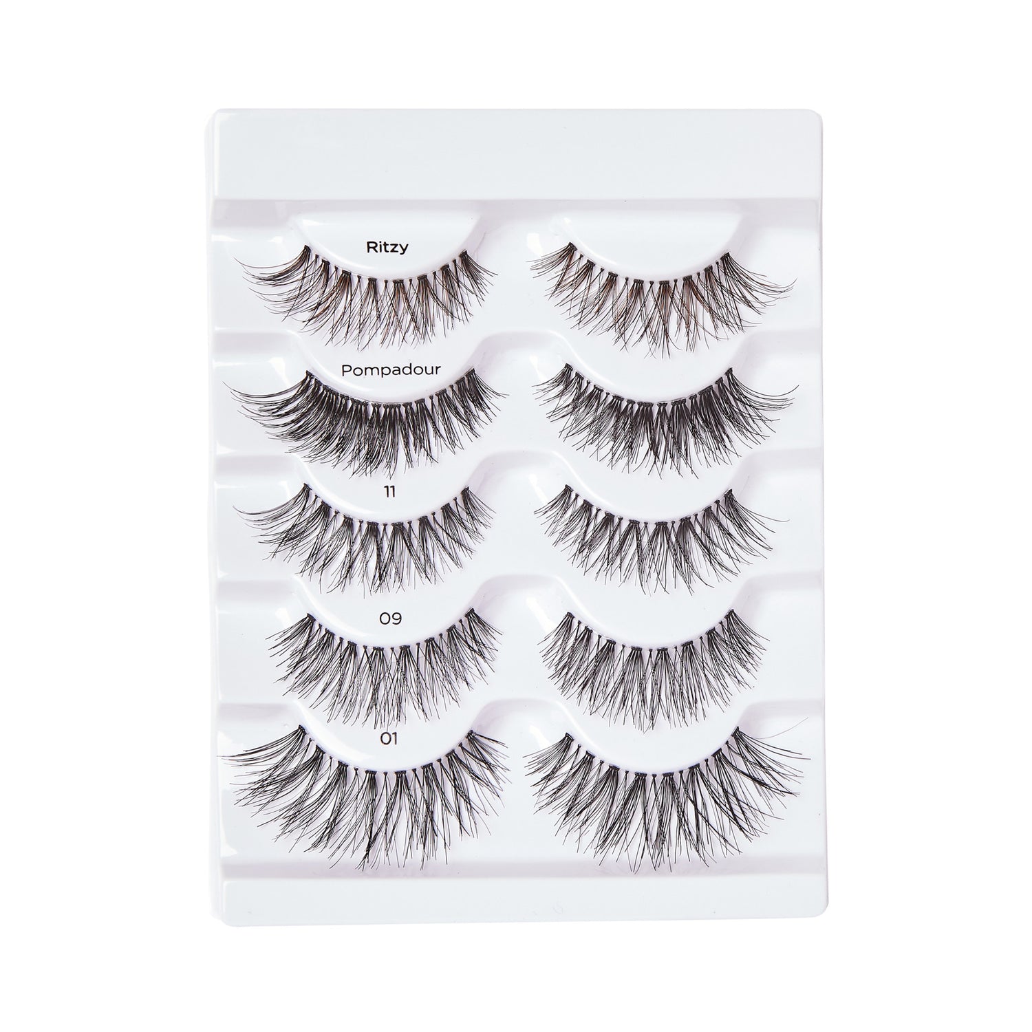 Five pairs of black false eyelashes displayed on a white plastic tray, each labeled with style names: Ritzy, Pompadour, 11, 09, and 01.