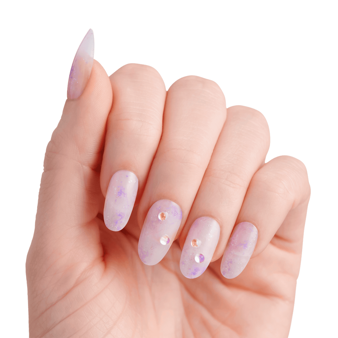 The image features a hand displaying elegantly manicured nails. The nails are long and shaped into a pointed style, showcasing a soft, translucent lavender color with a subtle gradient effect. Some nails are adorned with small, sparkling rhinestones, adding a touch of glamour. The overall look is delicate and stylish, set against a clean white background that emphasizes the beauty of the nails.