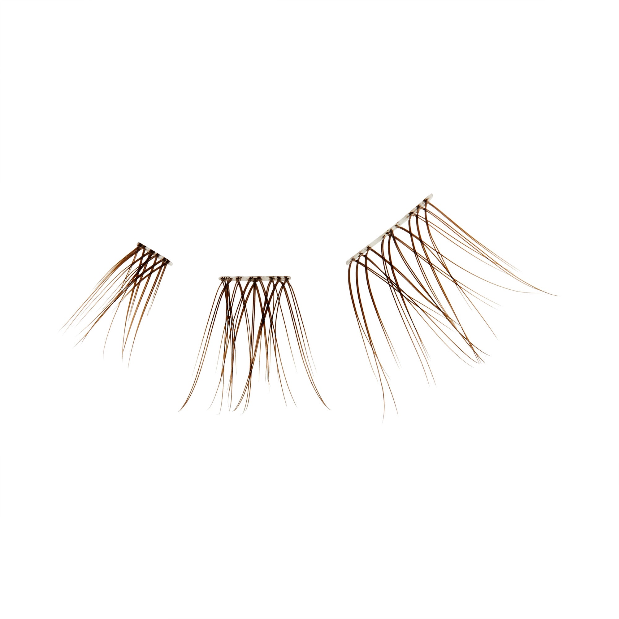 The image features three sets of false eyelashes arranged in a row. Each set varies in size and length, with the lashes appearing long and wispy. The lashes are a natural brown color, and they are displayed against a plain white background, emphasizing their shape and texture. The overall presentation suggests a focus on beauty and cosmetic enhancement.
