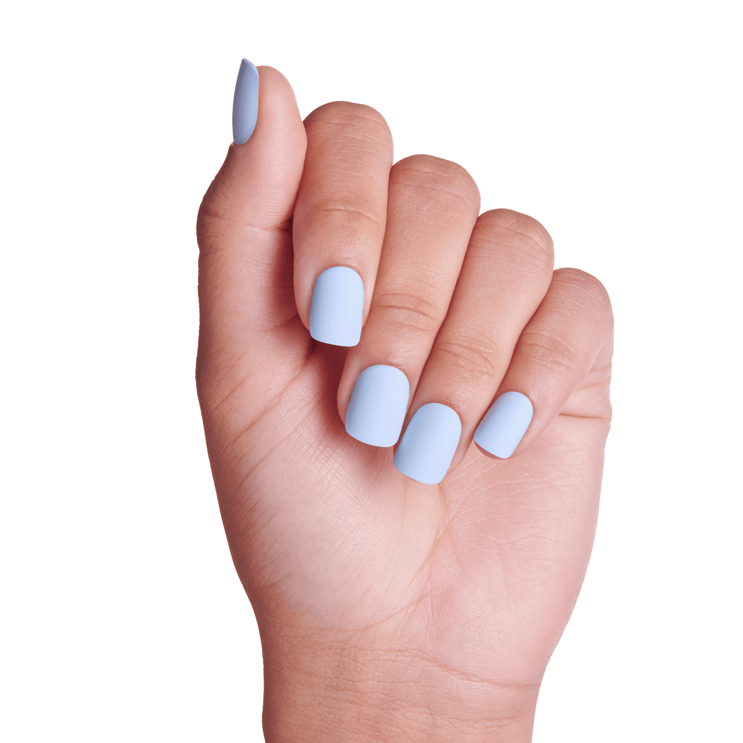 Hand with short, rounded press-on nails painted in a matte light blue shade called Blue Sky, shown against a transparent background.