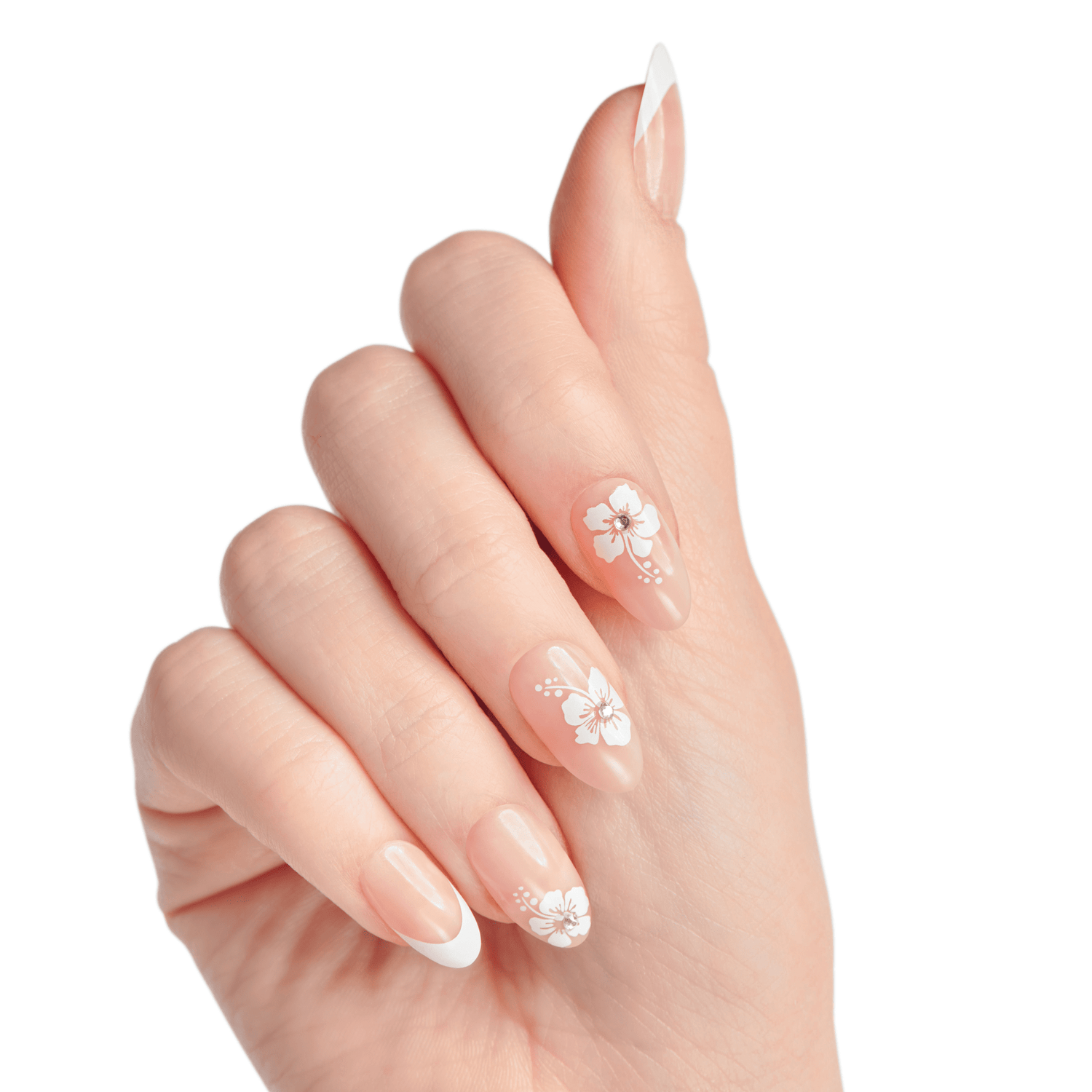 Hand with natural-toned press-on nails featuring white floral designs with small rhinestones on three nails and a classic white French tip on two nails, shown against a white background.