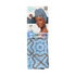 The image features a packaging for a satin wrap scarf from the brand Kiss Colors & Care. The scarf is designed in a light blue color with a decorative pattern that includes geometric shapes in darker shades. The packaging showcases a model wearing the scarf as a head wrap, highlighting its stylish appearance. The product is labeled as a limited edition and is described as being made from premium satin, measuring 60 inches in length. The overall presentation emphasizes both functionality and fashion.