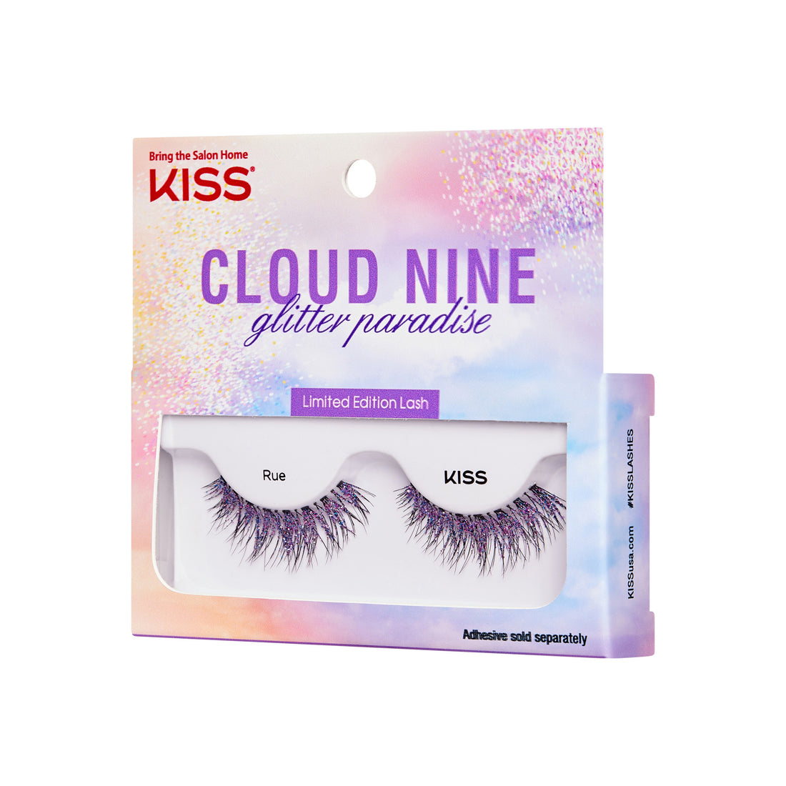 The image shows a product package for "KISS Cloud Nine Glitter Paradise" limited edition lashes. The packaging is colorful with a gradient of pastel hues, including pink, purple, and blue, and features a glittery design. The top of the package has the KISS logo and the tagline "Bring the Salon Home." The lashes are named "Rue" and are visible through a clear window in the packaging. The bottom of the package notes that adhesive is sold separately.