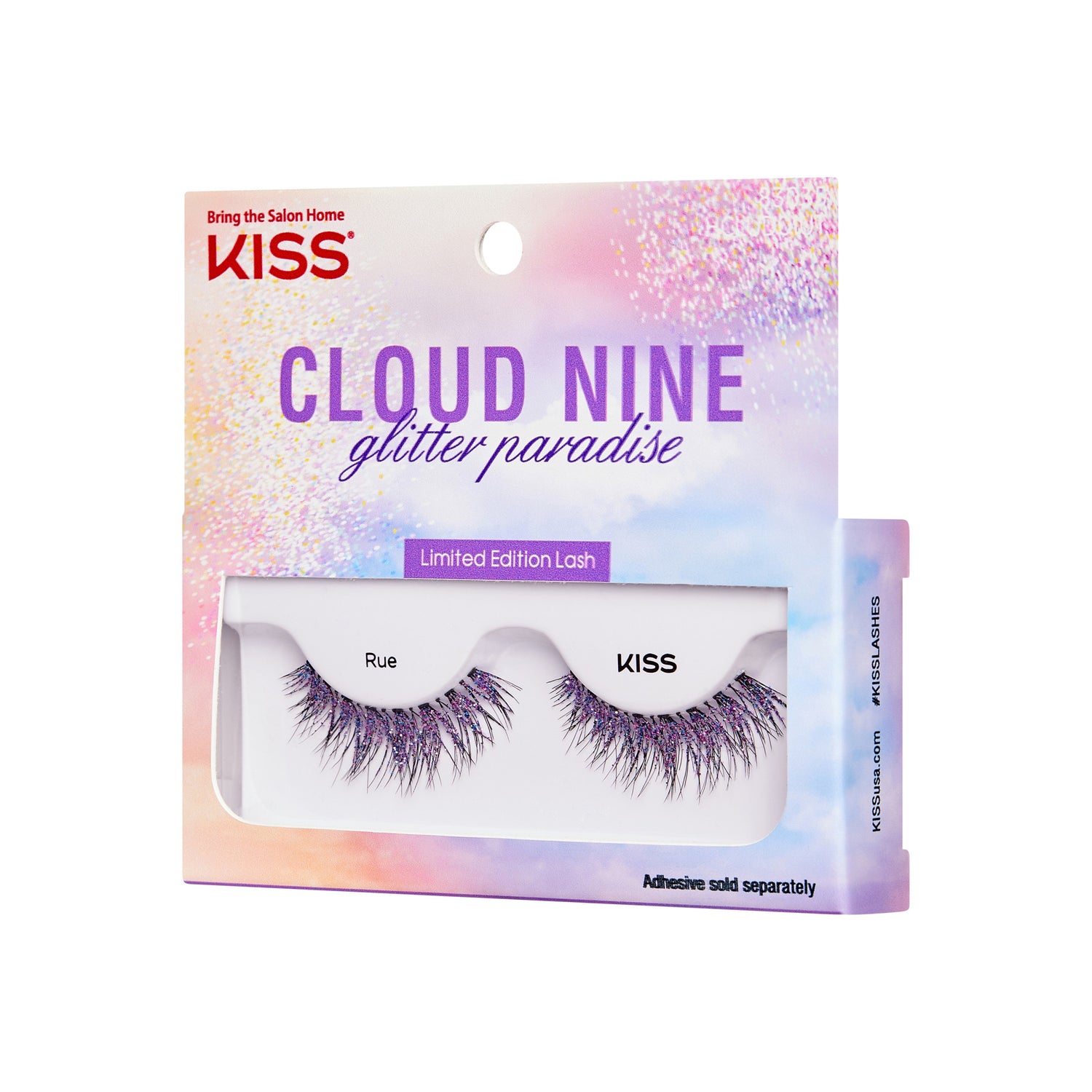 The image shows a product package for "KISS Cloud Nine Glitter Paradise" limited edition lashes. The packaging is colorful with a gradient of pastel hues, including pink, purple, and blue, and features a glittery design. The top of the package has the KISS logo and the tagline "Bring the Salon Home." The lashes are named "Rue" and are visible through a clear window in the packaging. The bottom of the package notes that adhesive is sold separately.