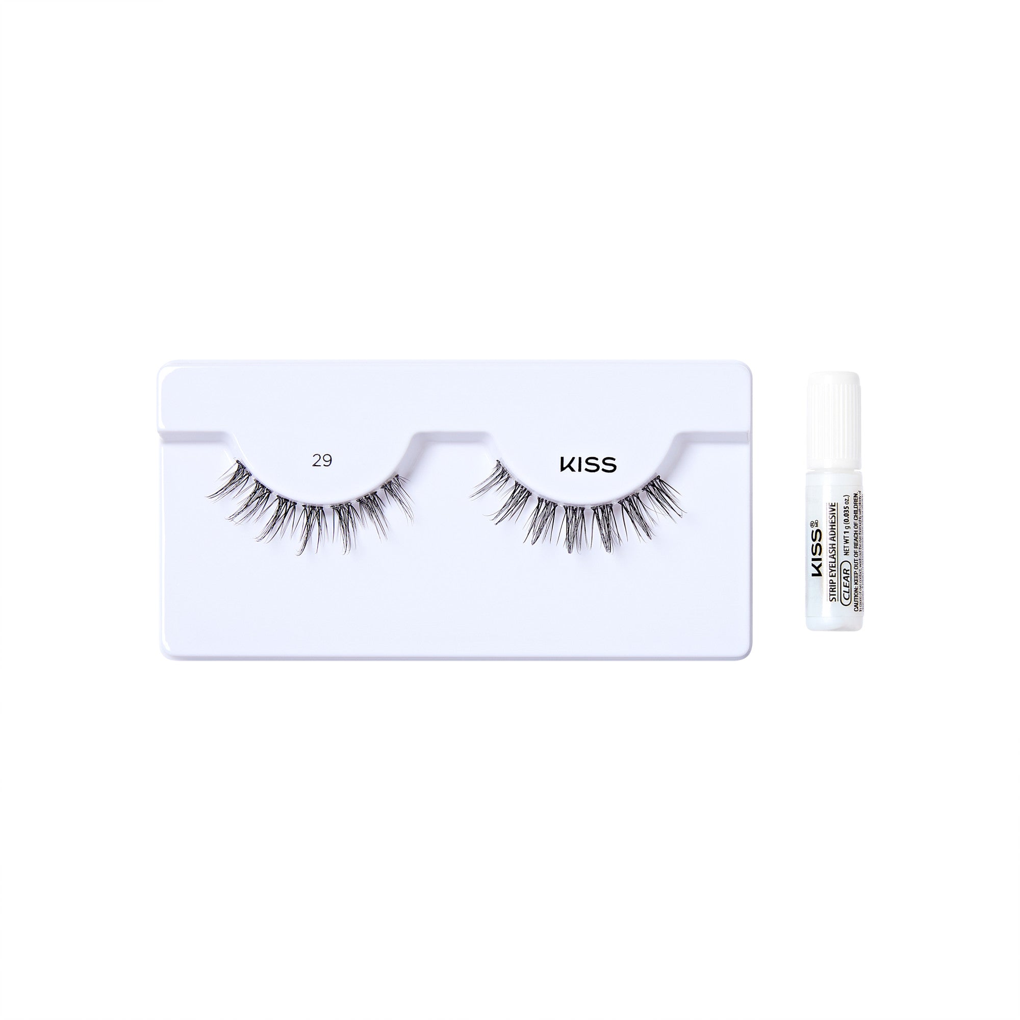 The image shows a set of false eyelashes and an adhesive glue. The false eyelashes are displayed on a white plastic tray, with the number "29" printed on the left side and the brand name "KISS" on the right side. The eyelashes are arranged in a natural, wispy style. To the right of the tray, there is a small white tube of adhesive glue, also branded with "KISS" and additional text indicating it is a strip lash adhesive. The overall presentation is clean and minimalistic, highlighting the product.