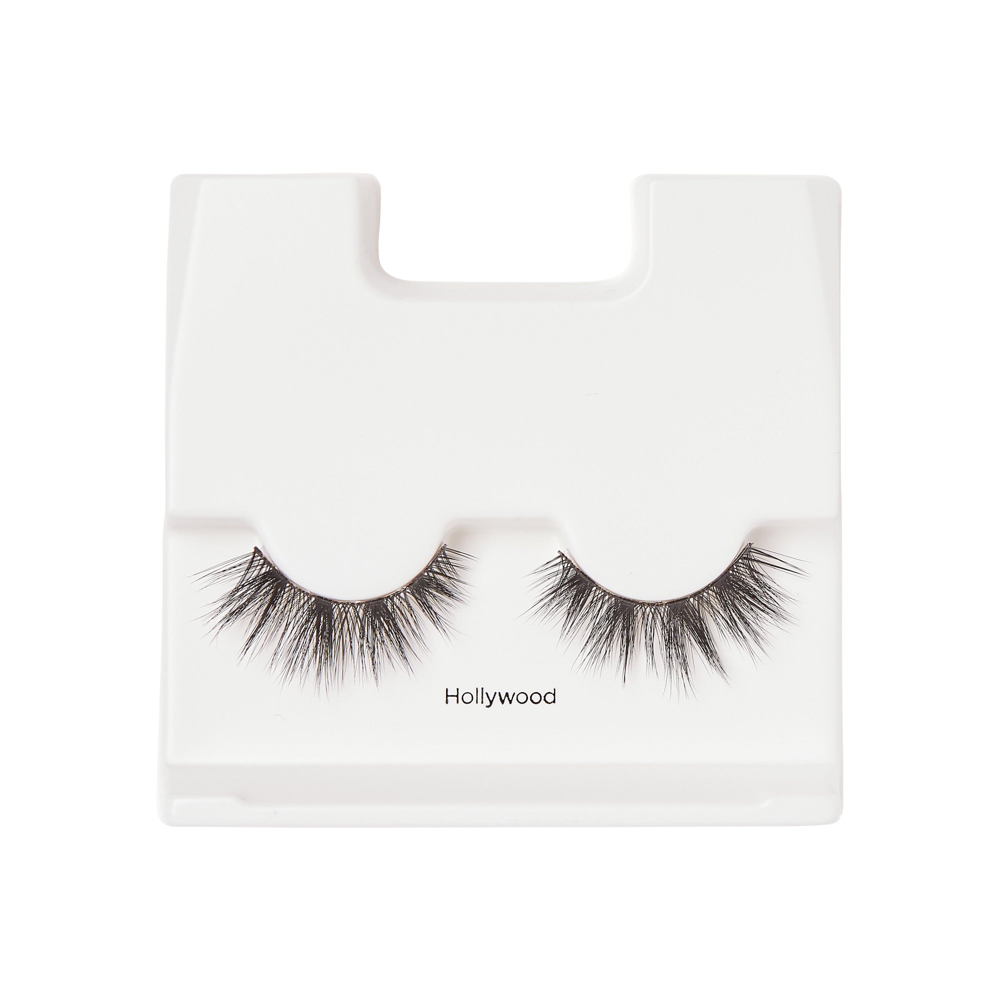 Pair of black false eyelashes with a fluttery, voluminous style displayed on a white plastic tray labeled \