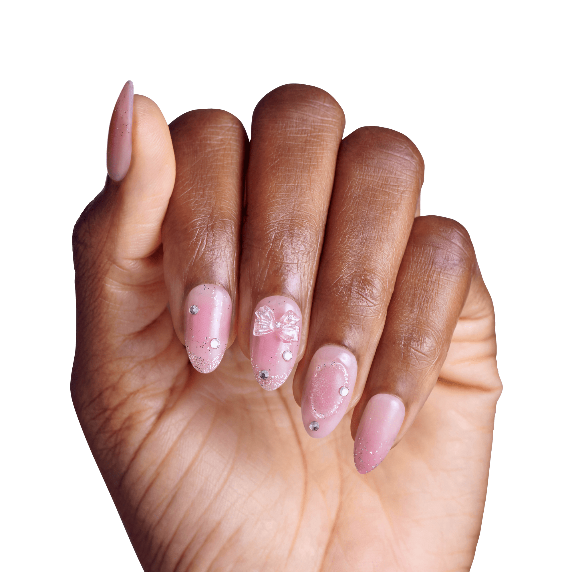 Manicured hand displaying pink gel nails with rhinestone embellishments and bow design.