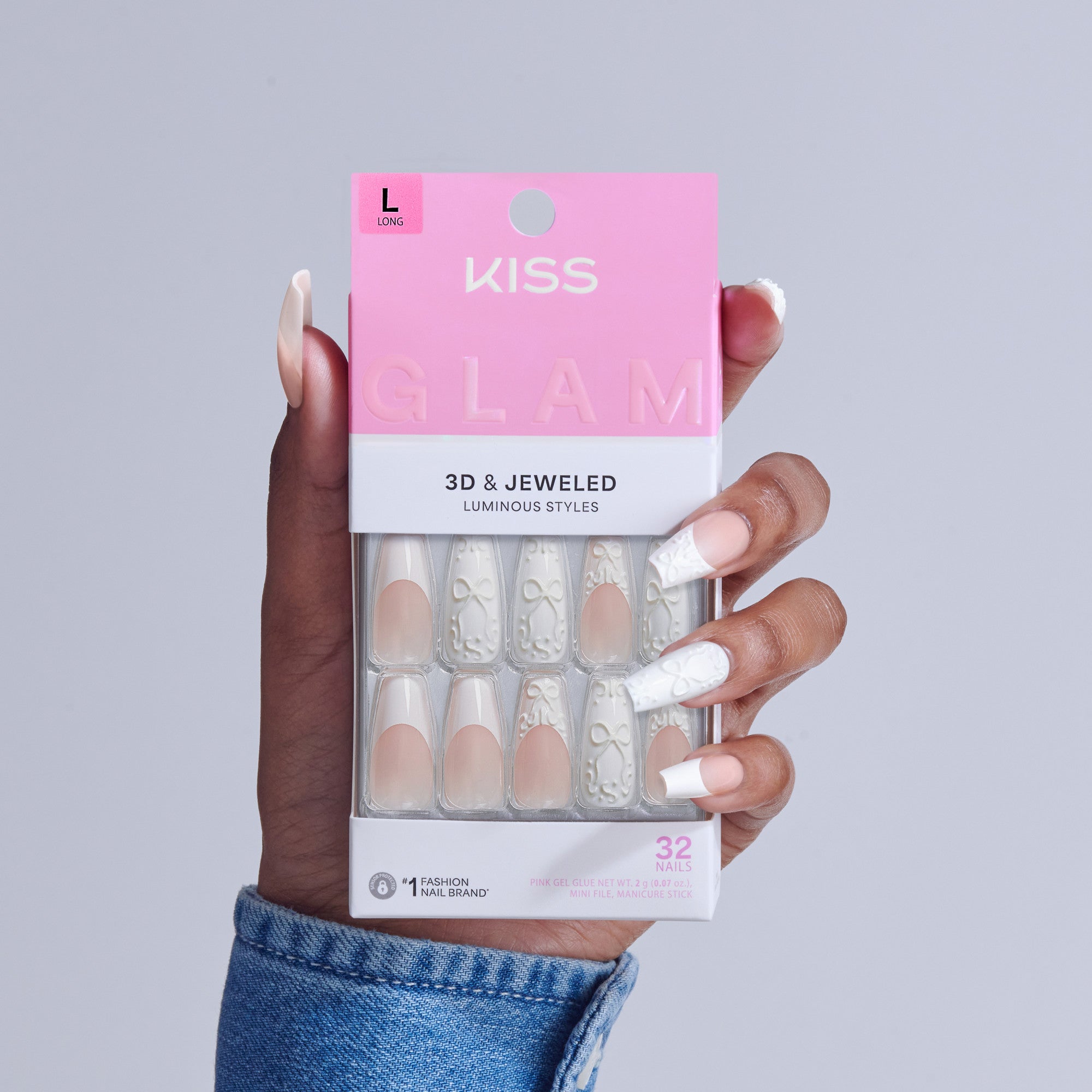 KISS Glam 3D &amp; Jeweled false nails in size L, displayed in packaging held by hand.