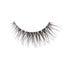 The image shows a single false eyelash. The eyelash is curved and features a dense arrangement of fine, black synthetic fibers that taper to a point, mimicking the appearance of natural eyelashes. The base of the eyelash is thicker and darker, designed to adhere to the eyelid. The fibers are arranged in a way that provides a voluminous and dramatic look. The background of the image is plain white, highlighting the details of the eyelash.