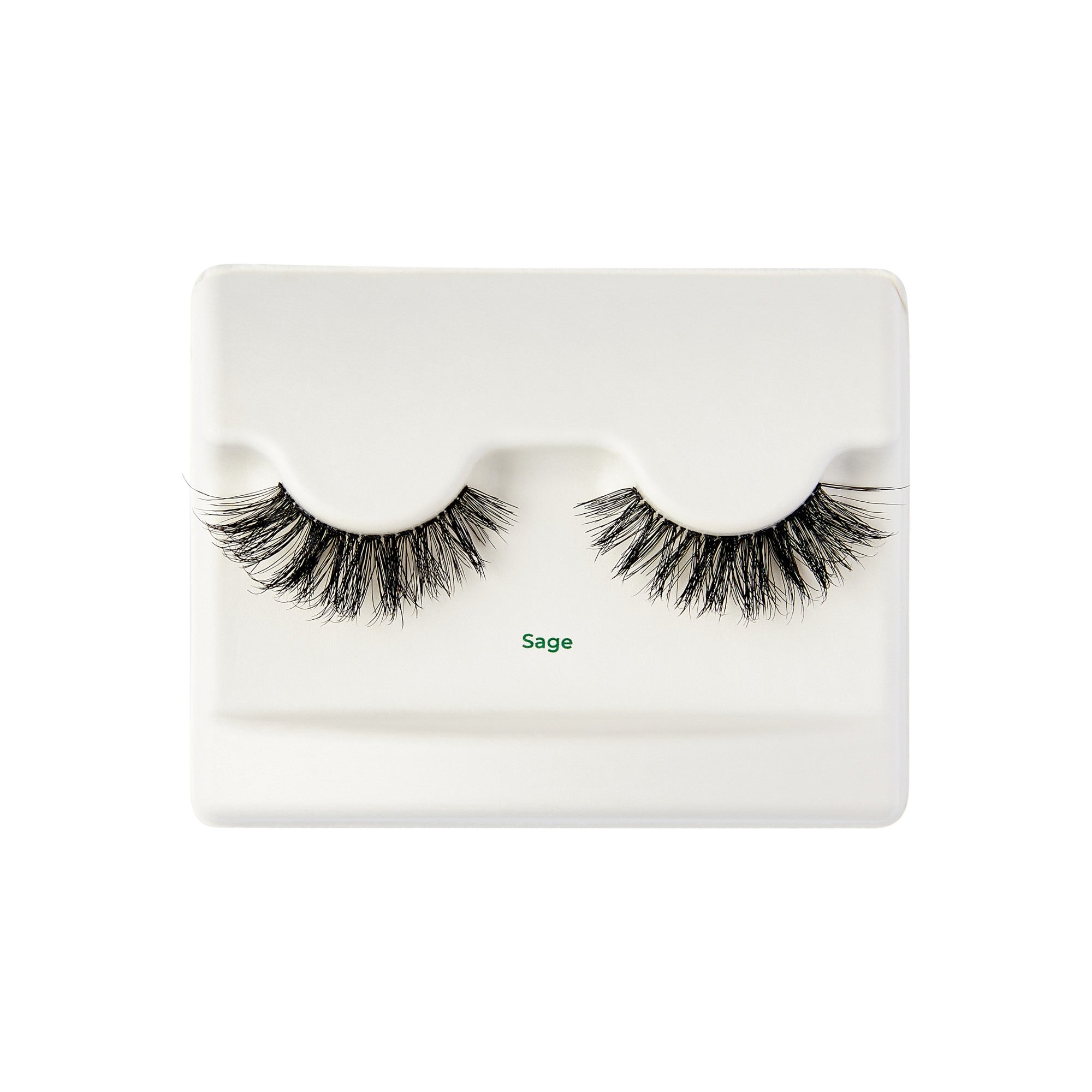 The image shows a pair of false eyelashes displayed on a white plastic tray. The eyelashes are thick and voluminous, with a natural-looking curl. The tray has a slight indentation to hold the lashes in place. Below the lashes, the word "Sage" is printed in green text. The overall presentation is clean and minimalistic.